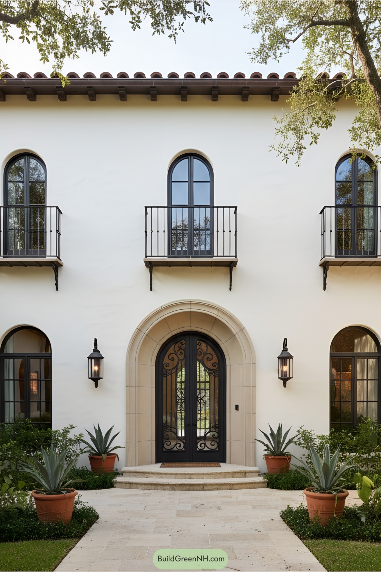 Mediterranean-style house with arched windows and potted plants