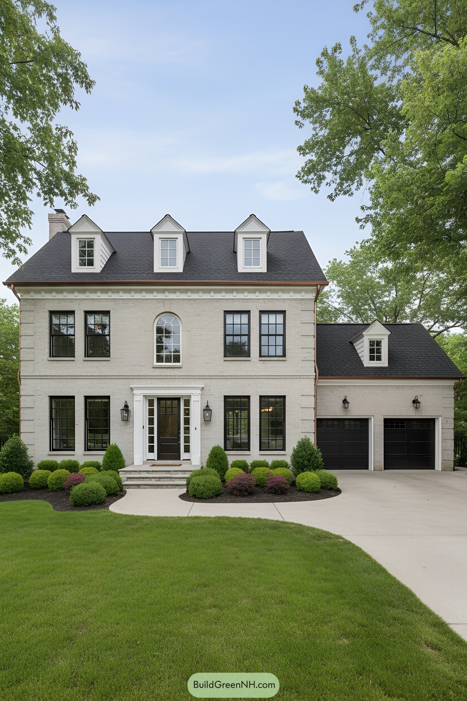 Three-story brick colonial with black windows and dormers, attached two-car garage