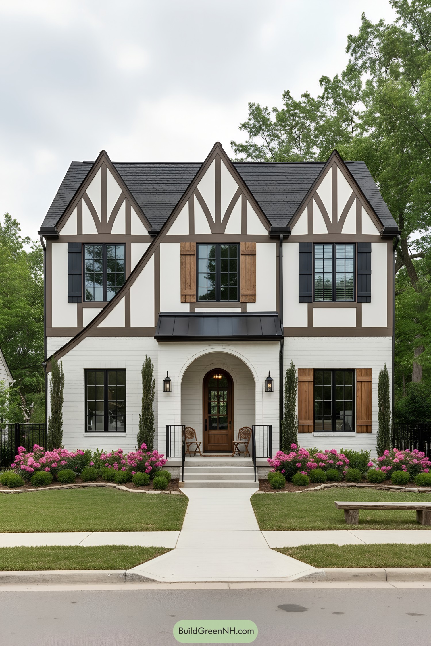 White-brick Tudor facade with dark trim, arched porch, and wooden shutters
