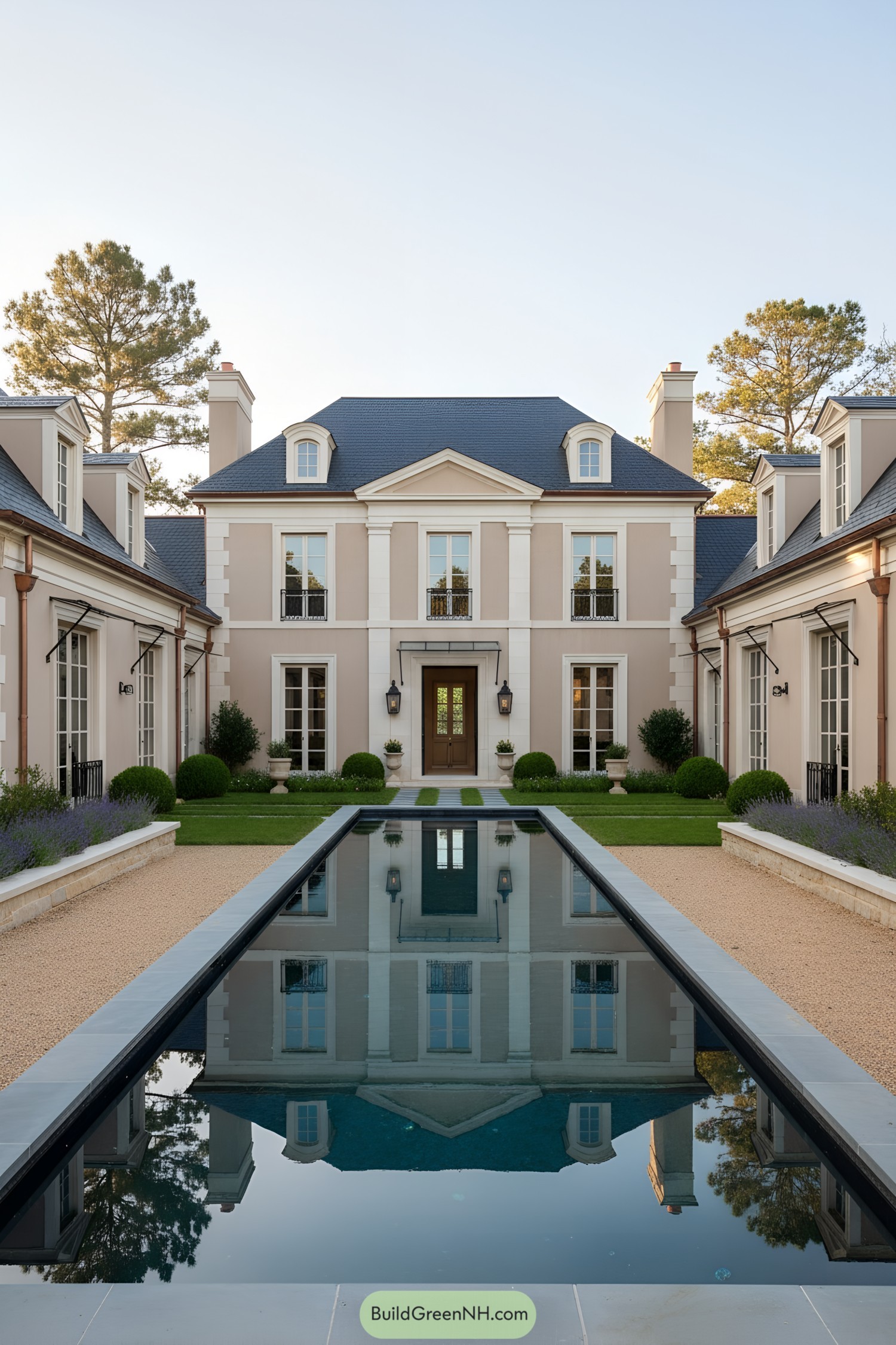 Symmetrical French-style courtyard home with long reflecting pool