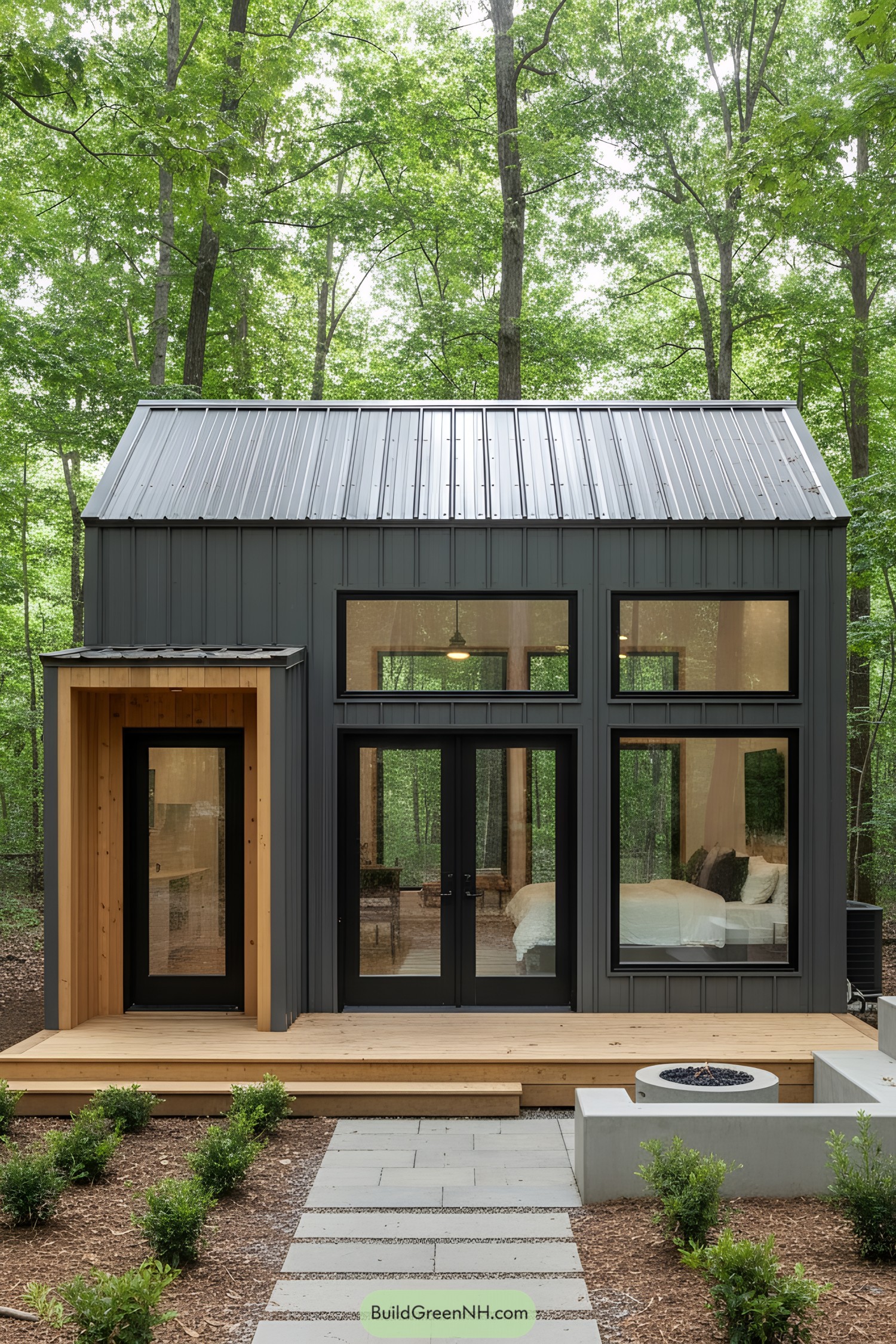 Tiny house with modern steel design nestled in lush woods
