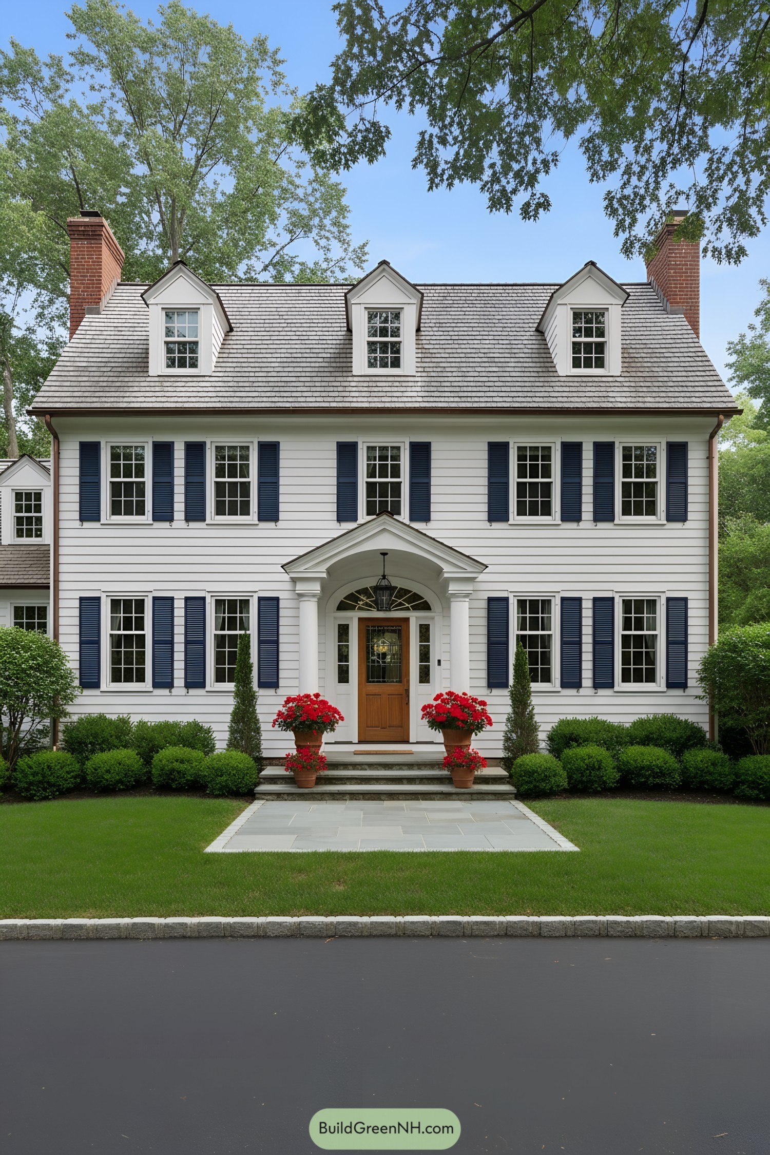 White clapboard colonial with blue shutters and arched portico