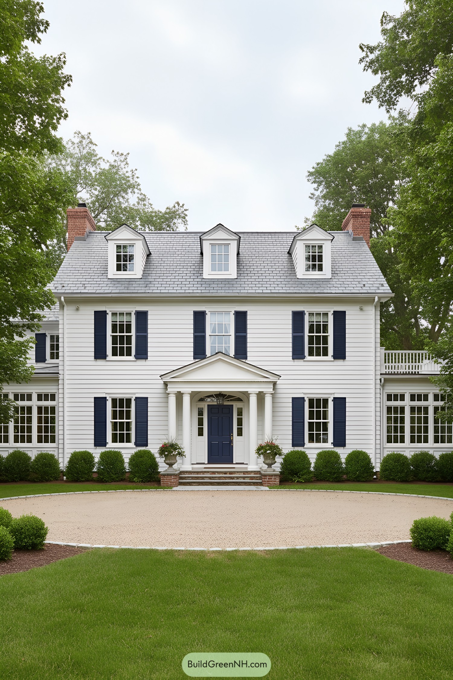 White clapboard colonial with navy shutters and dormers