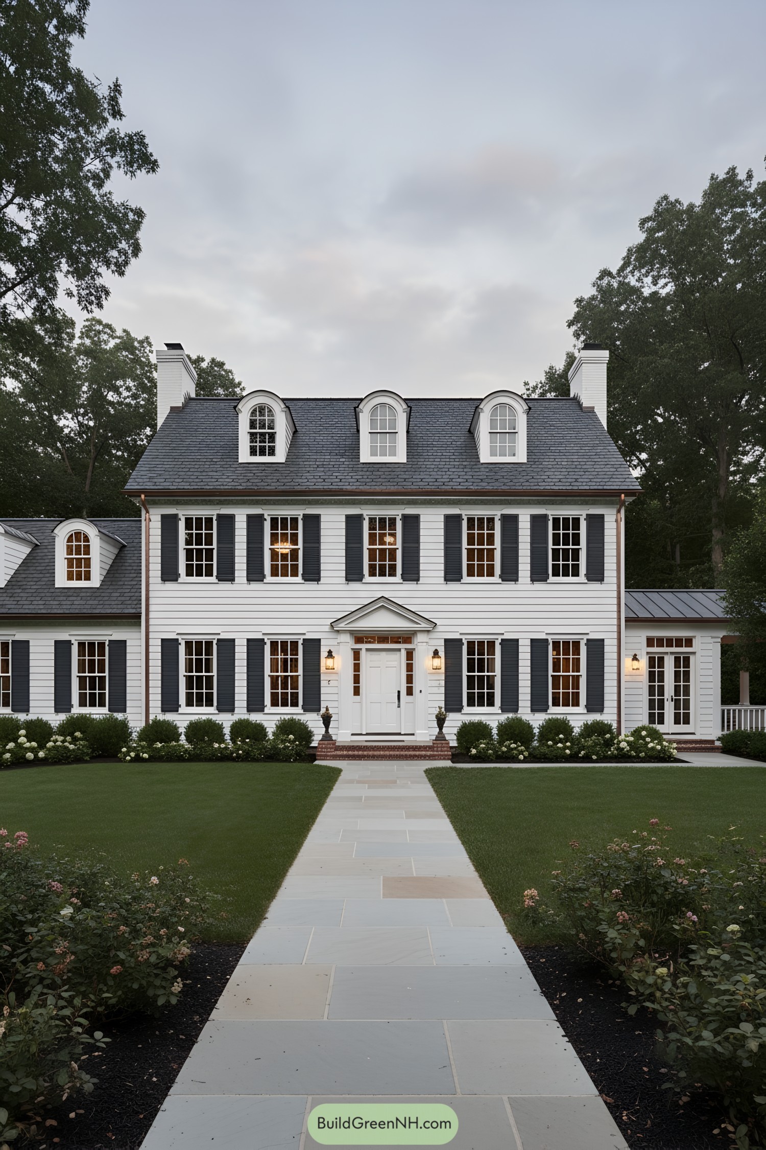 White colonial house with black shutters and dormers