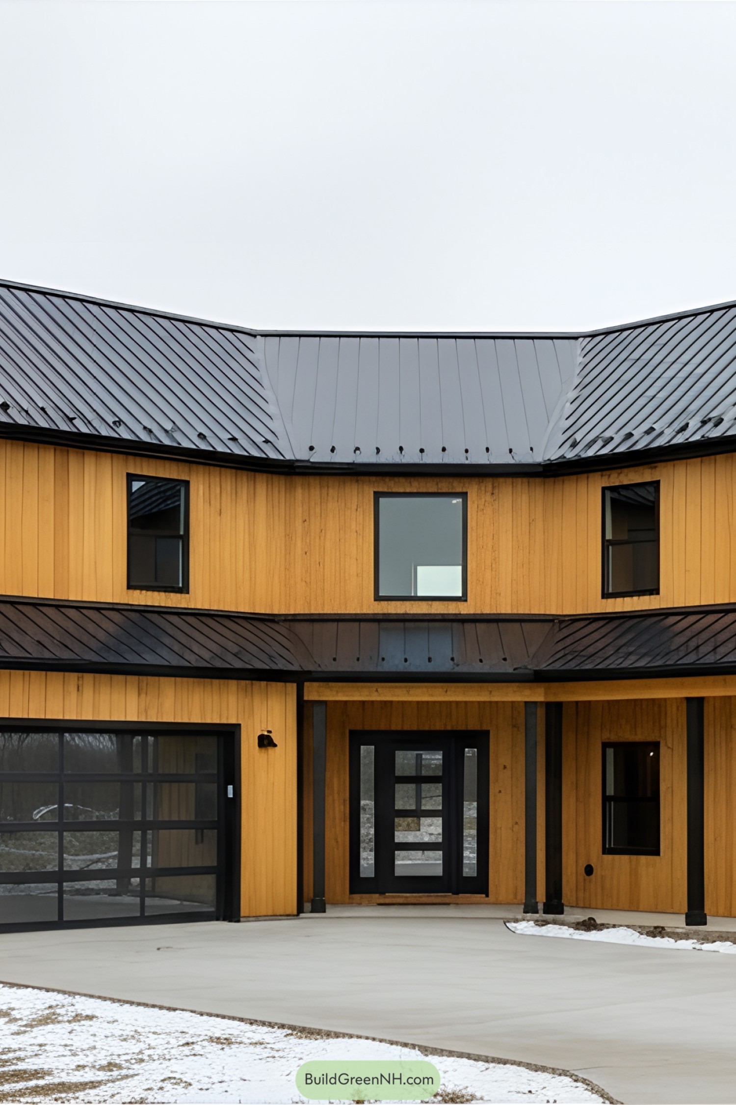 Modern yellow barndominium with black roof