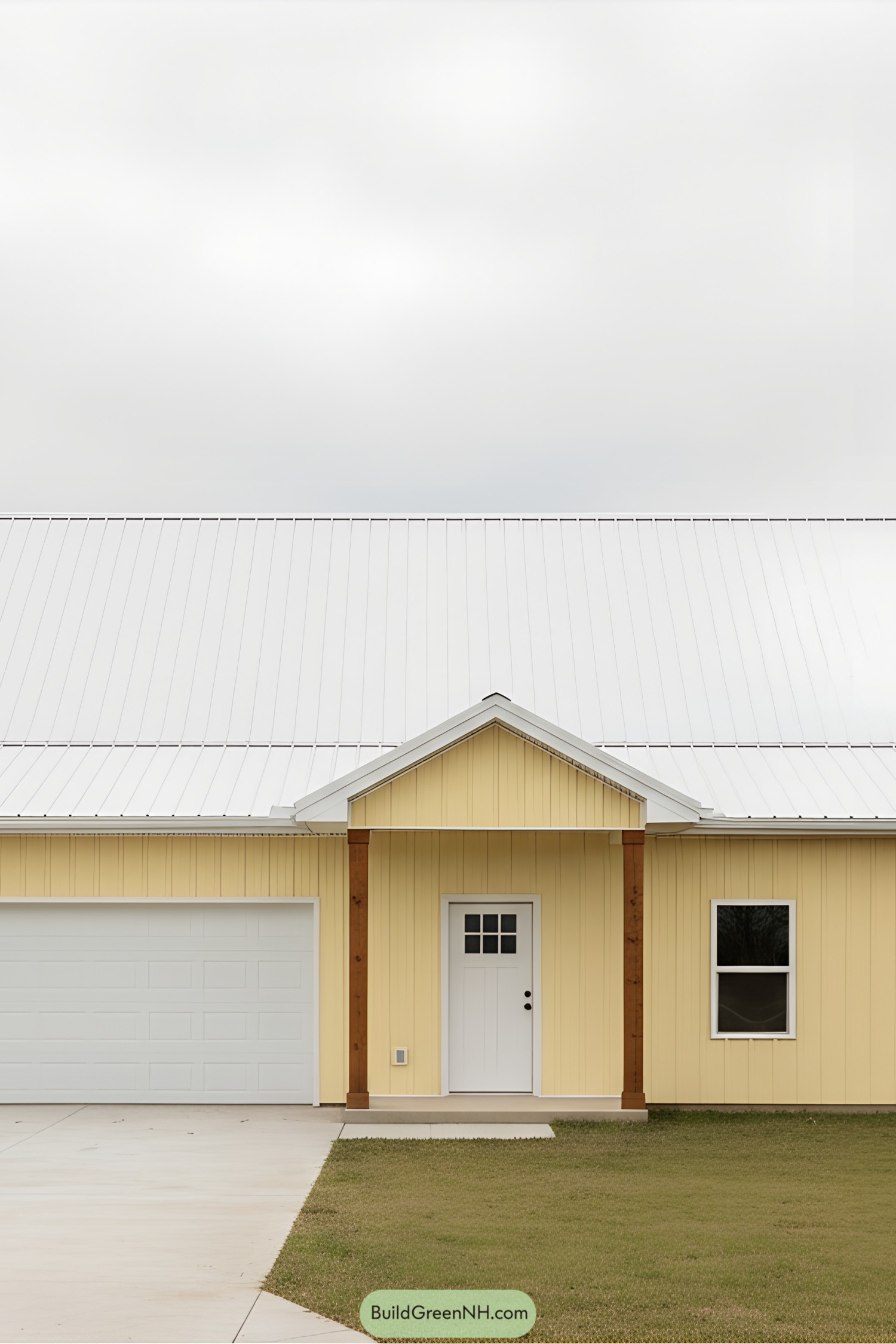 Yellow barndominium with a white roof and brown accents