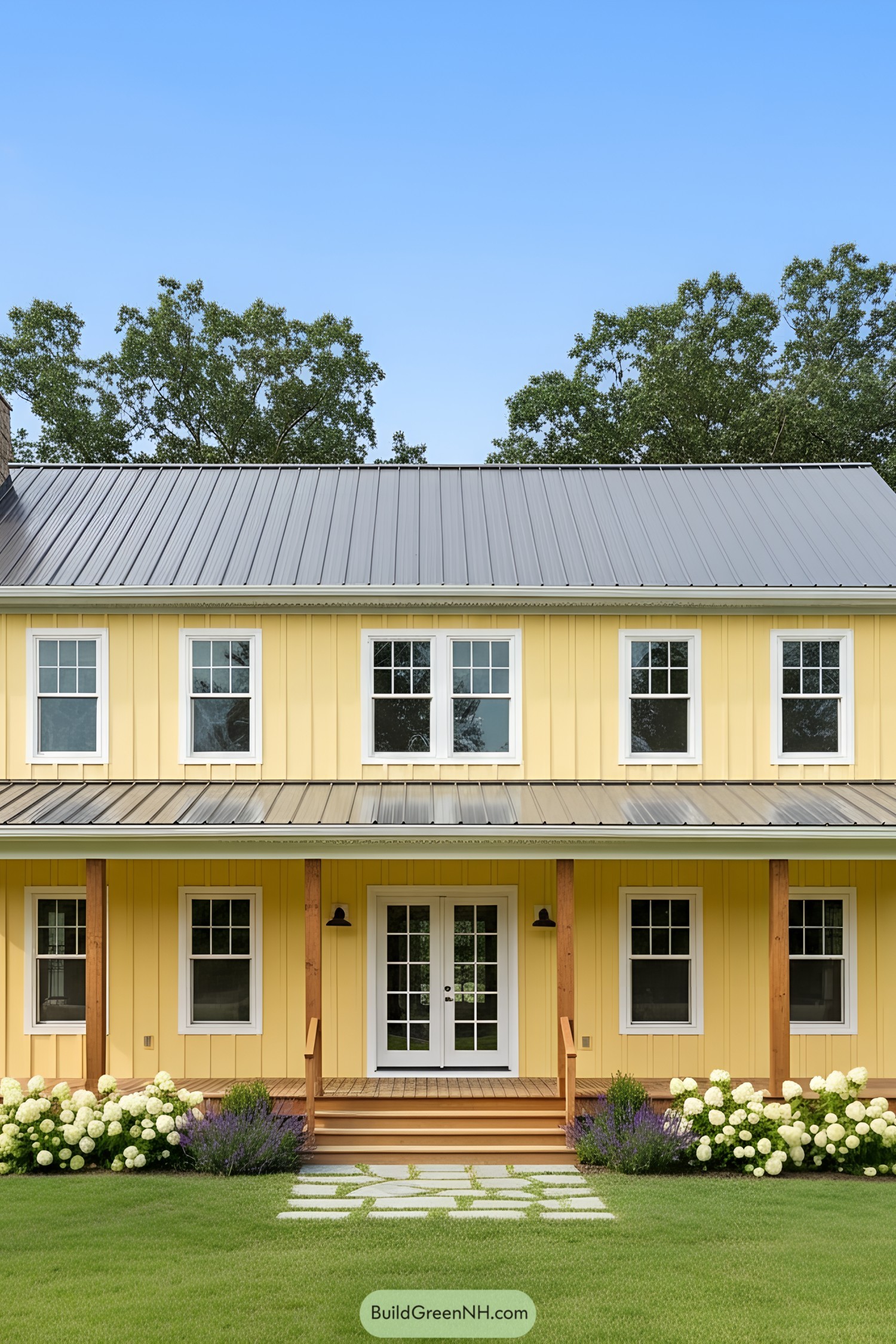 Yellow barn home with white trim and flower beds