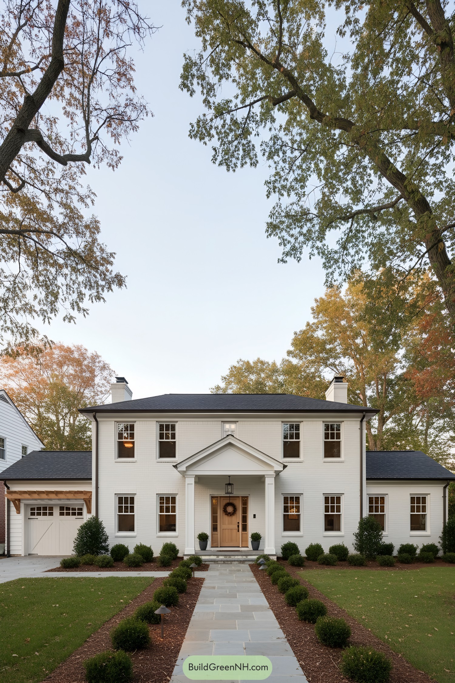 White brick colonial with pedimented portico and oak door