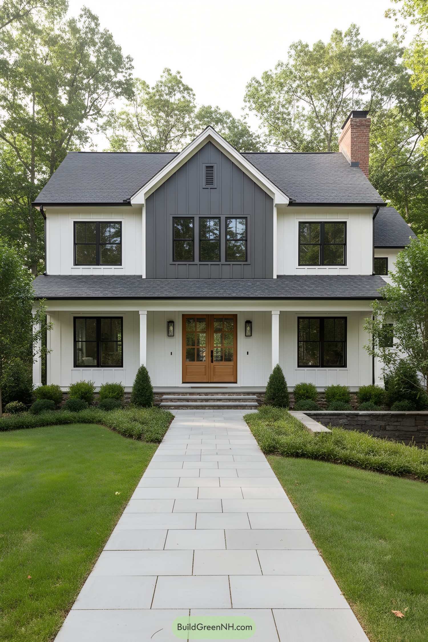 White board-and-batten home with a charcoal center gable, black windows, and a cedar double door
