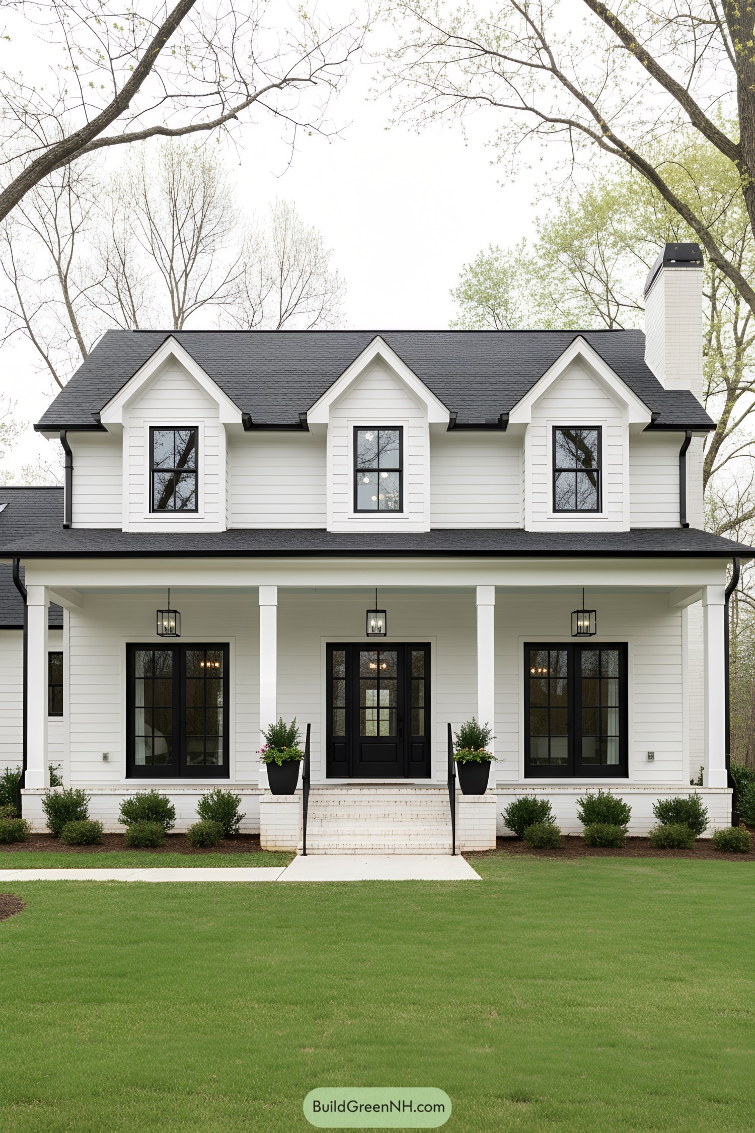 White colonial with triple dormers and porch