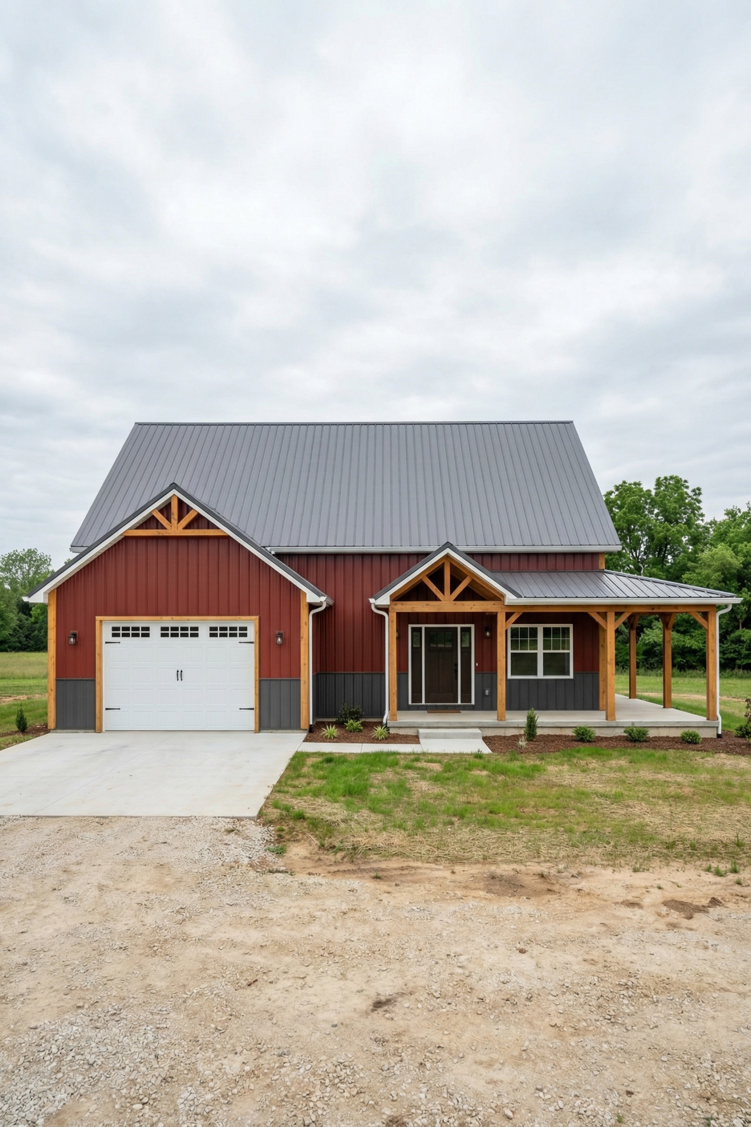 Red barnhouse with gray metal roof, timber posts, side porch, and single garage