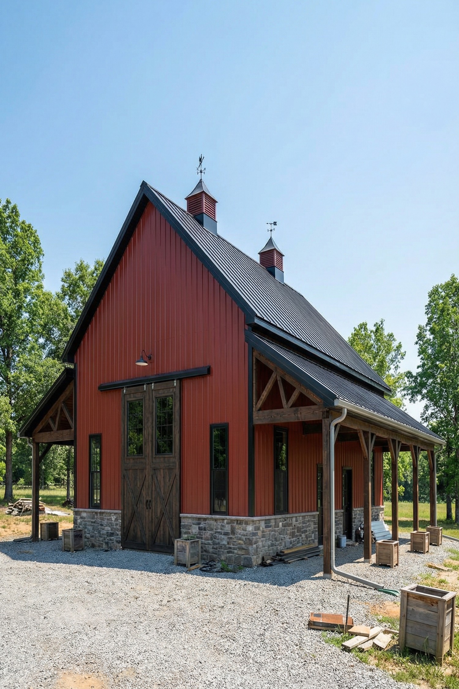 Red barn with stone base and twin cupolas