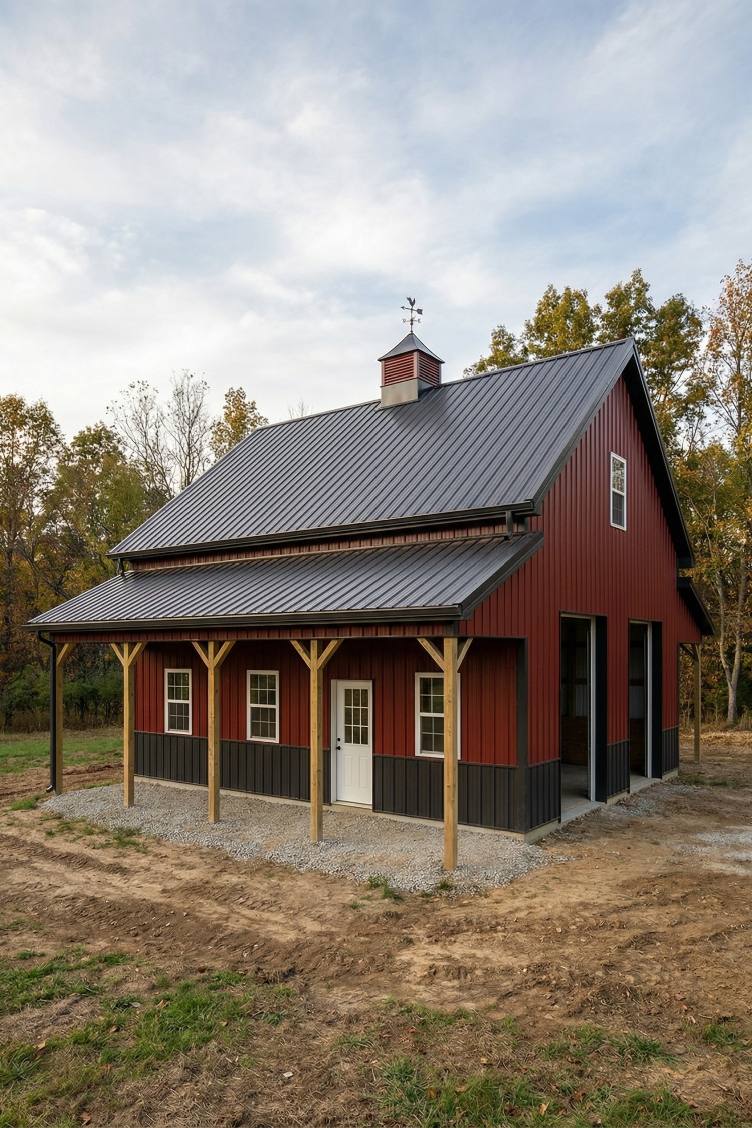 Red barn with black metal roof and lean-to porch