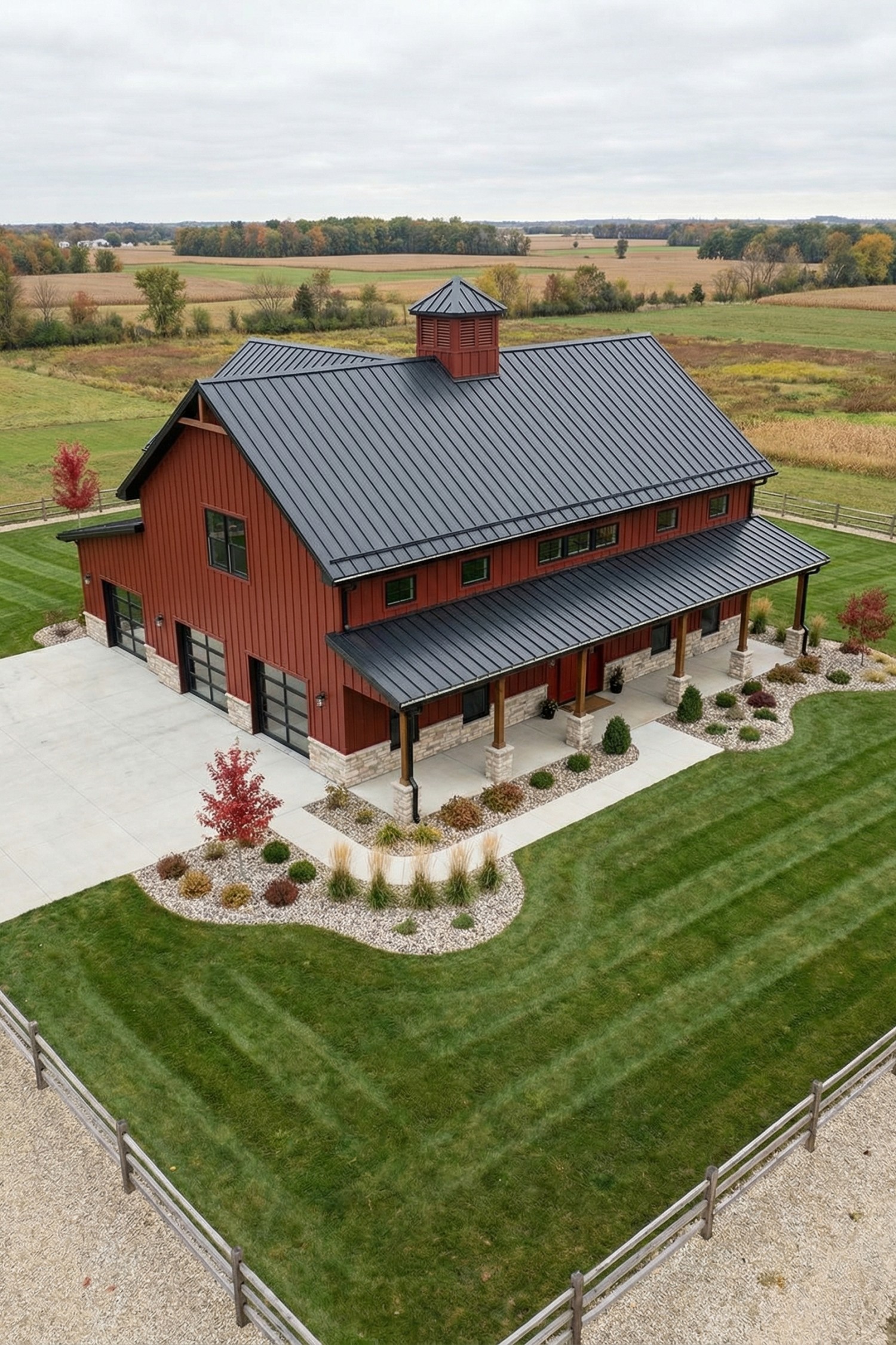Red barn with black metal roof and long covered porch