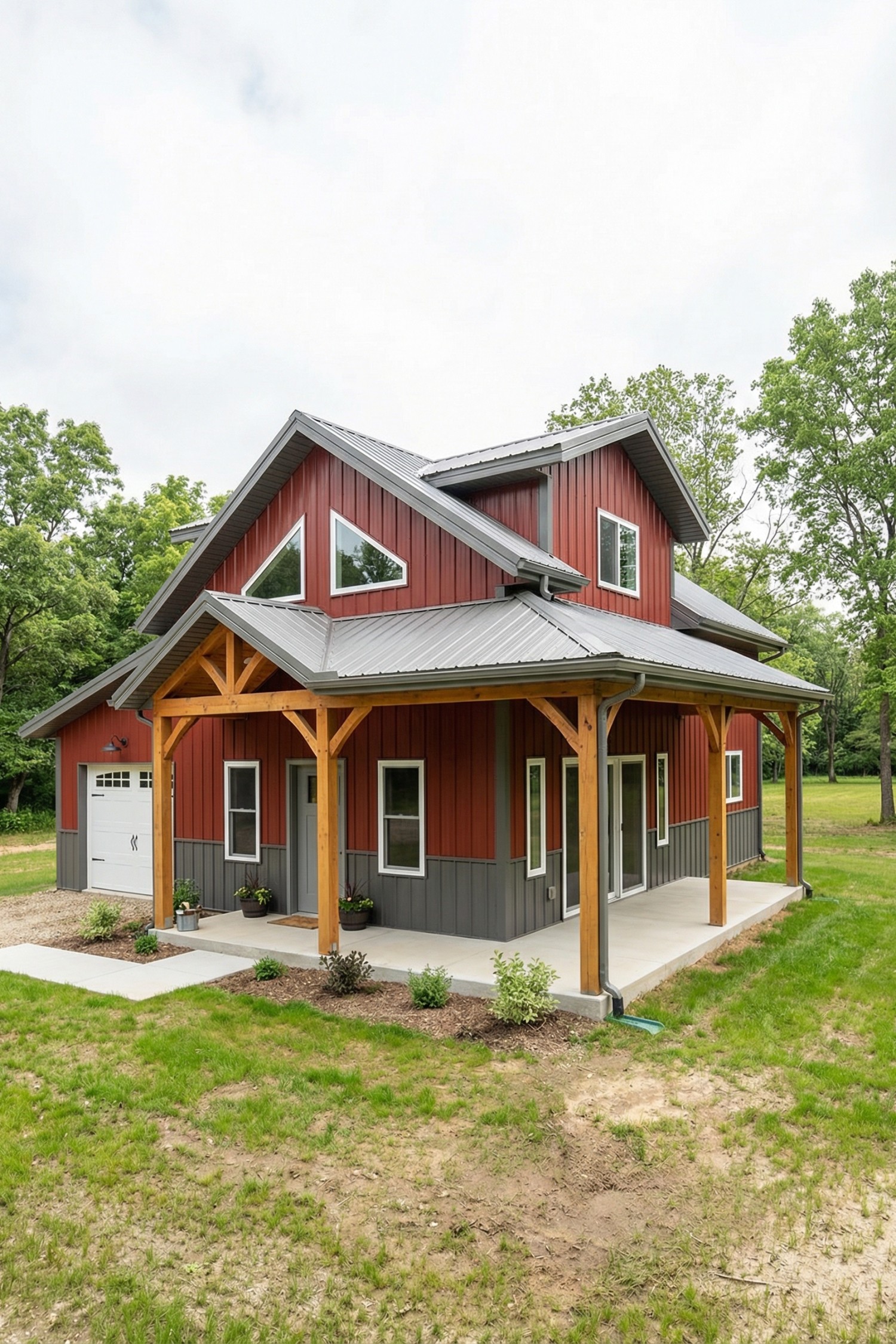 Red barnhouse with gray metal roof and timber posts