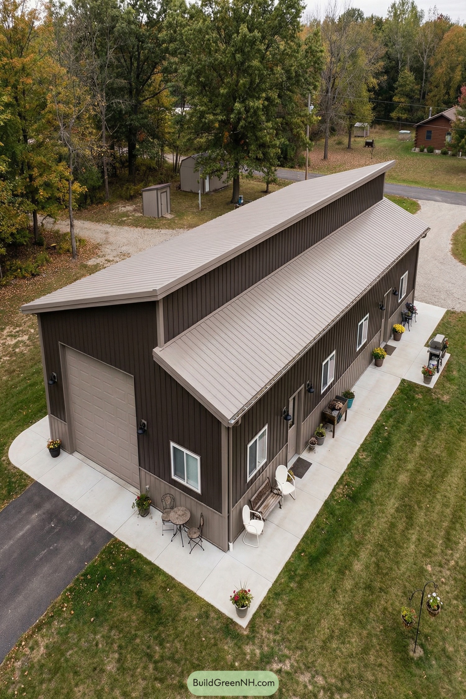 Brown metal pole barn house with tall garage bay and long shed roofline