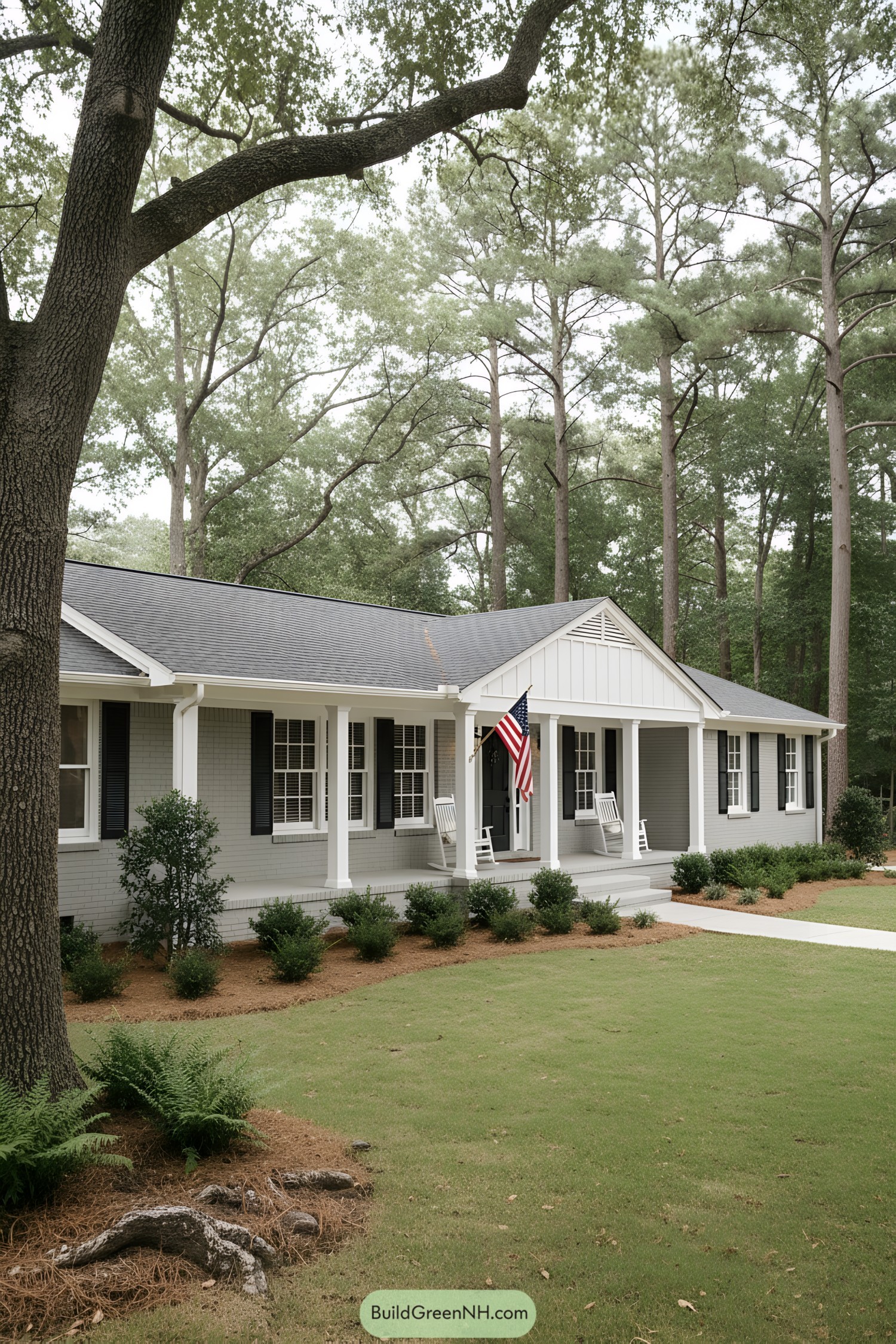 Gray brick ranch with long front porch and rocking chairs under tall pines
