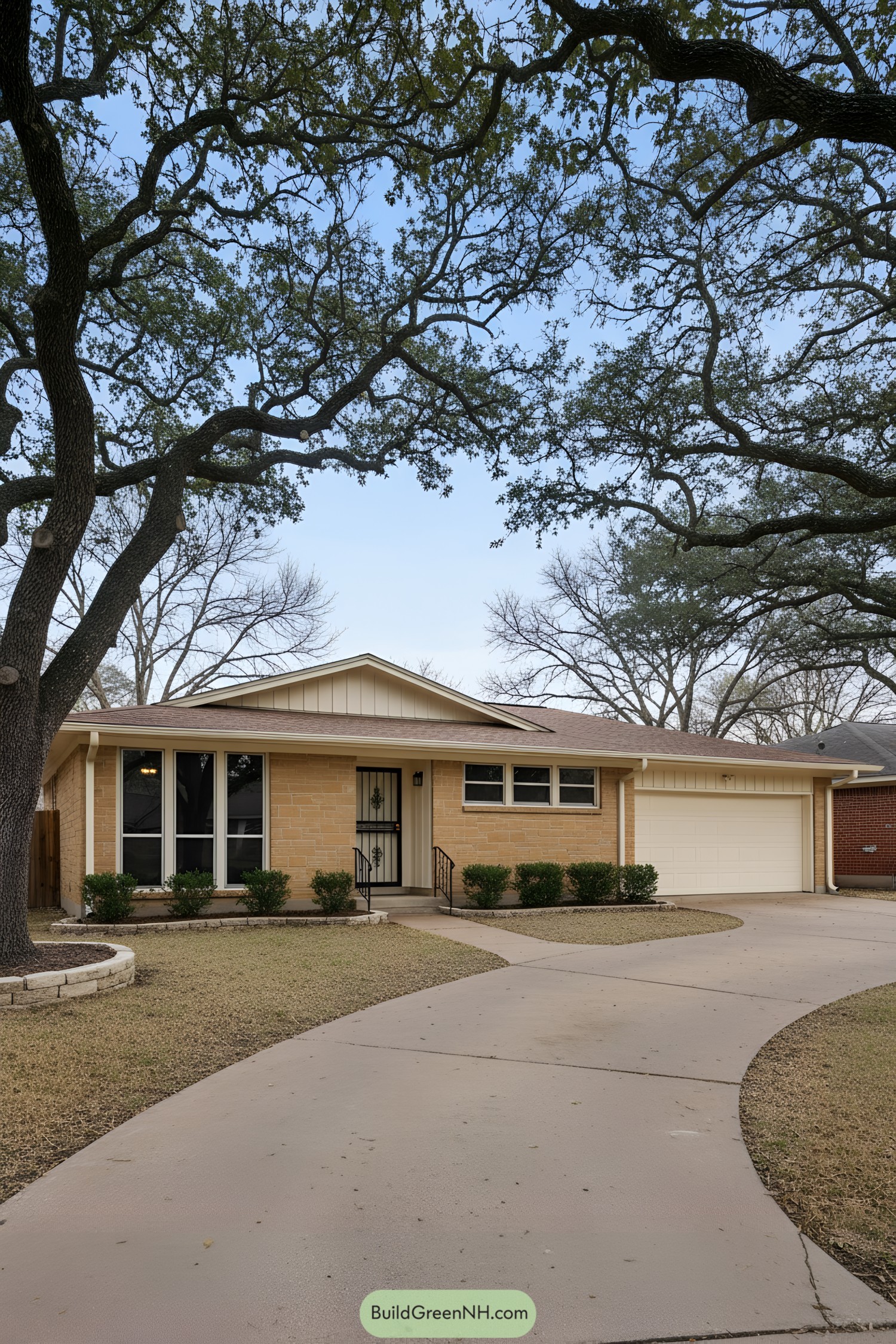 Single-story tan-brick ranch with front gable, picture windows, and curved driveway
