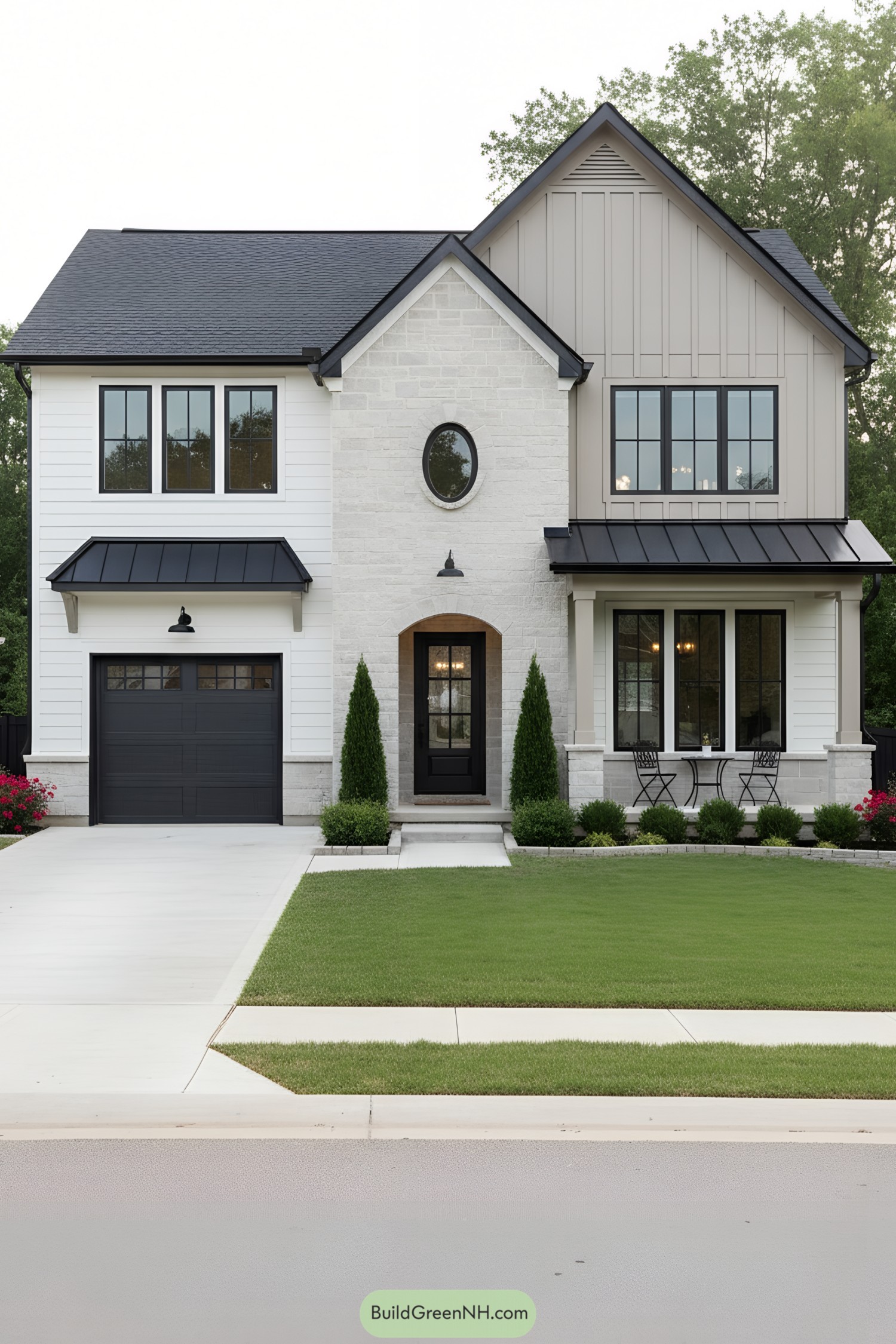 Two-story suburban home with pale stone, black windows, and metal awnings