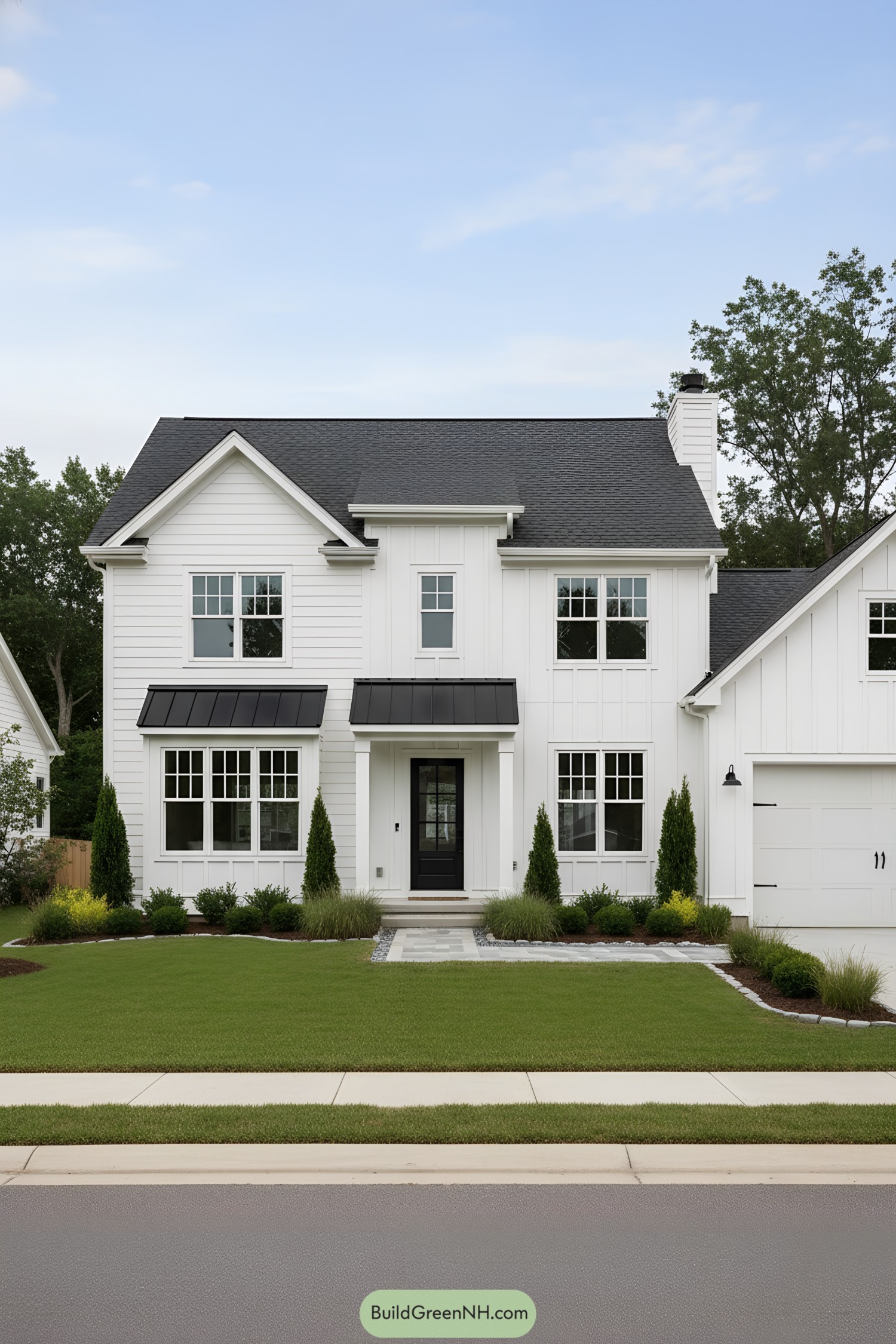 White farmhouse with black metal accents and gable roof