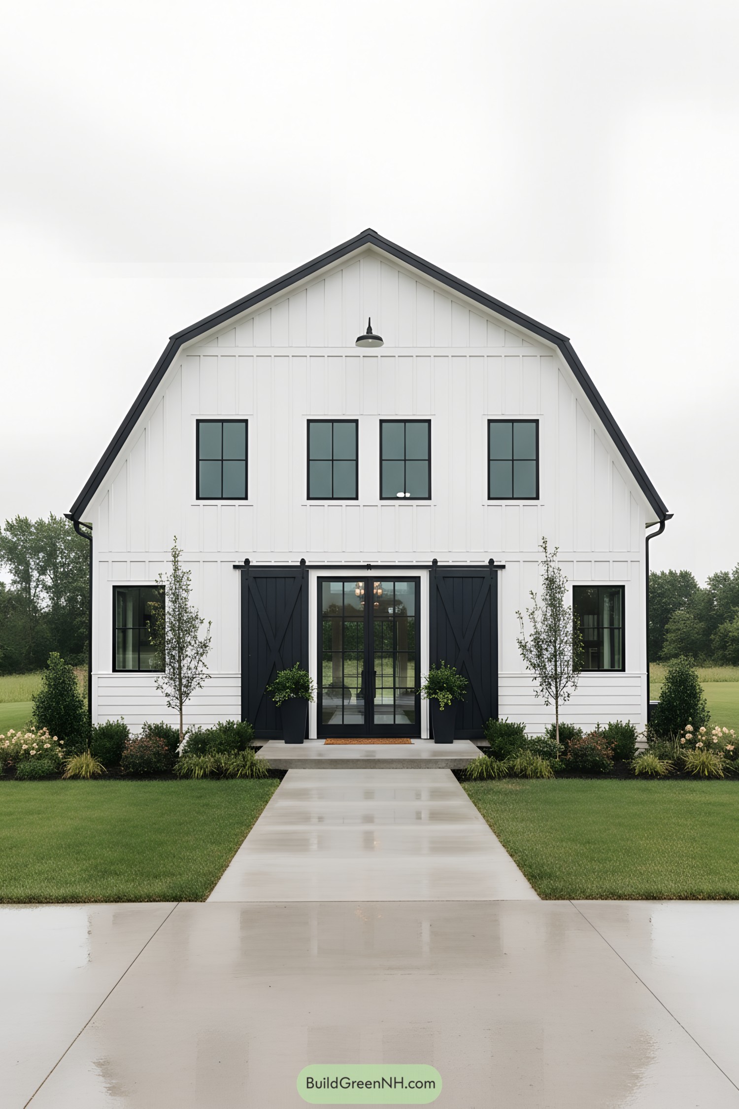 White barn-style house with black accents and large central glass doors