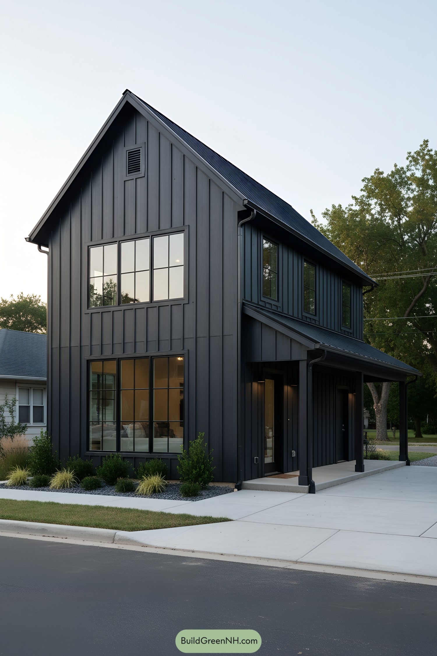 Black metal barndo with tall windows and side porch
