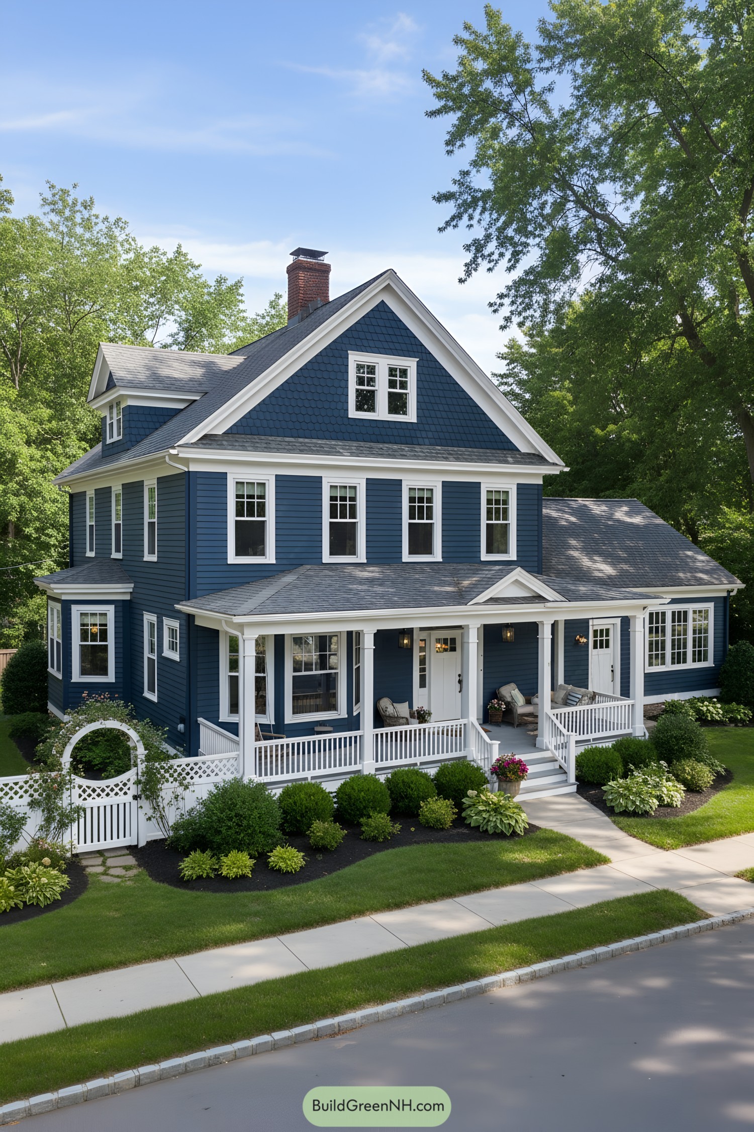 Deep-blue gabled house with white trim and wraparound porch
