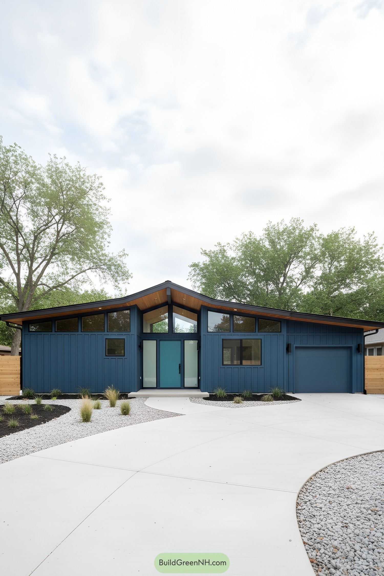 Modern blue ranch with butterfly roof and glass front door