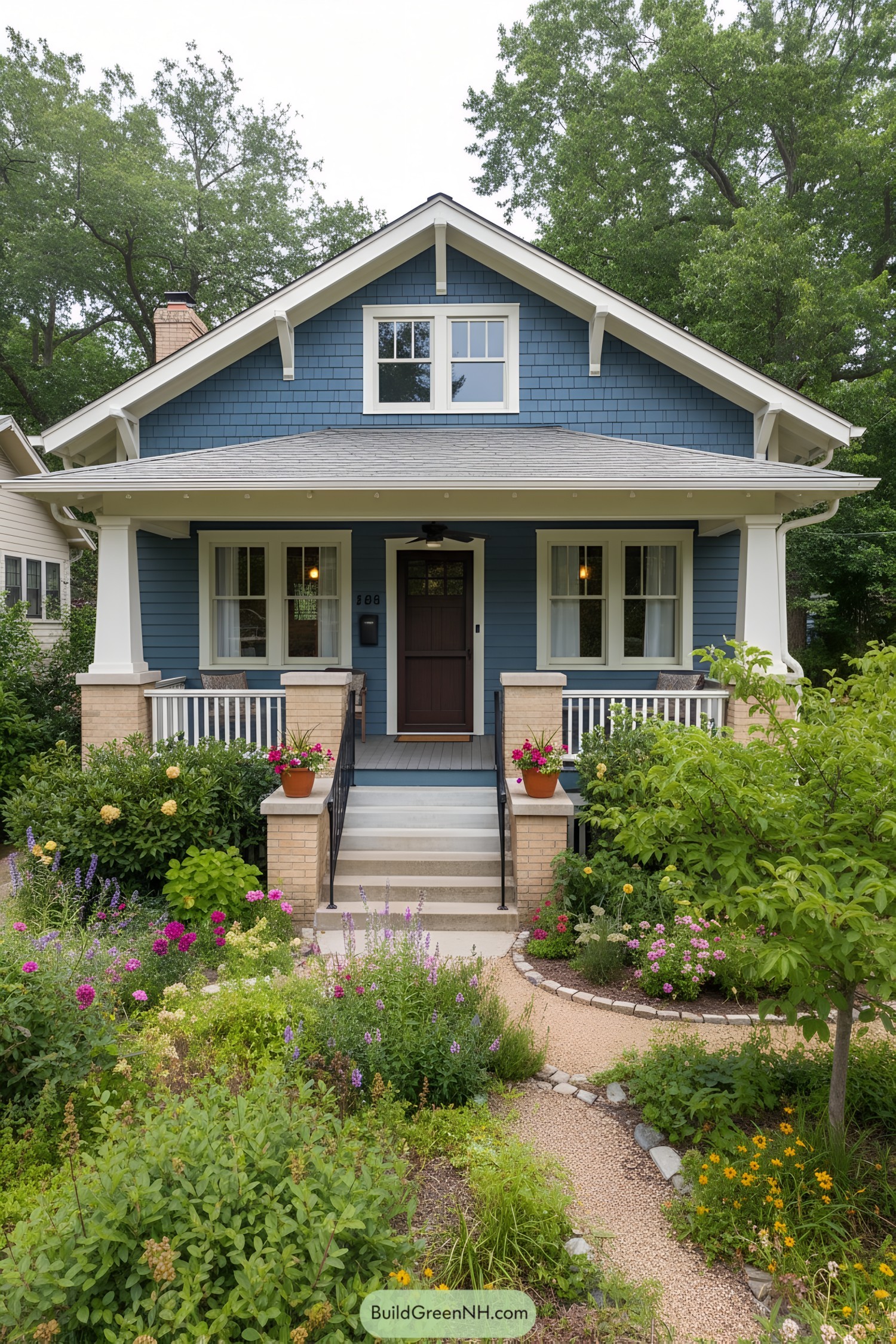 Blue craftsman bungalow with porch and garden