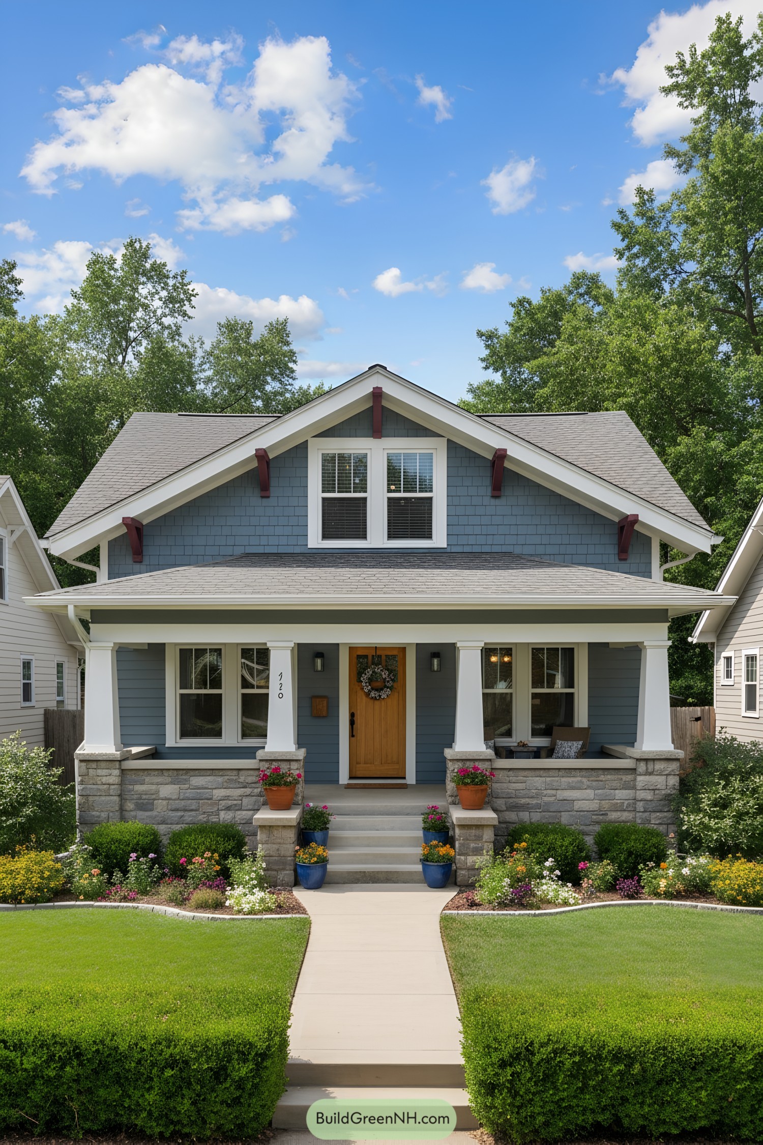 Blue craftsman bungalow with stone porch and gable brackets