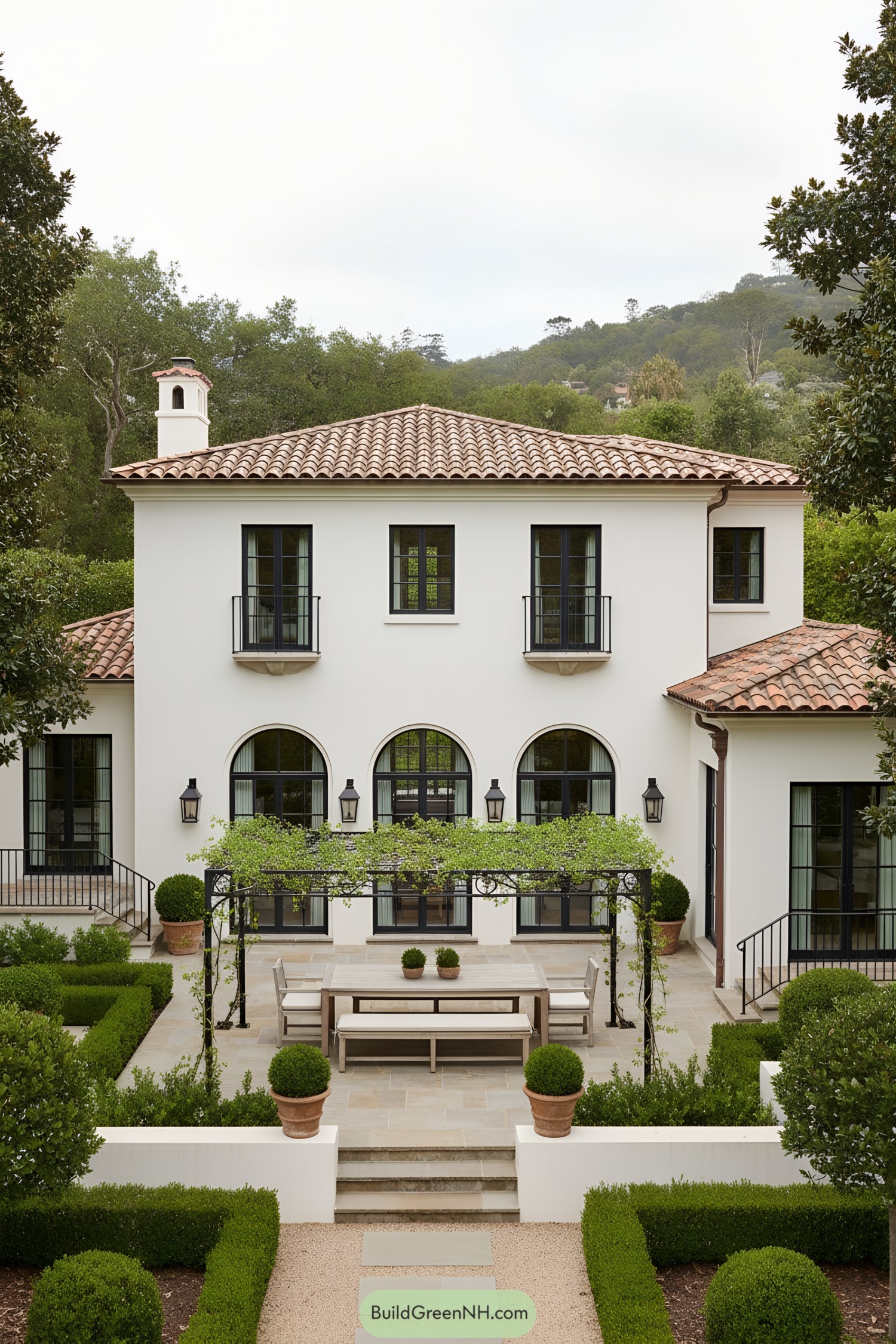 Mediterranean villa with arched windows and pergola courtyard