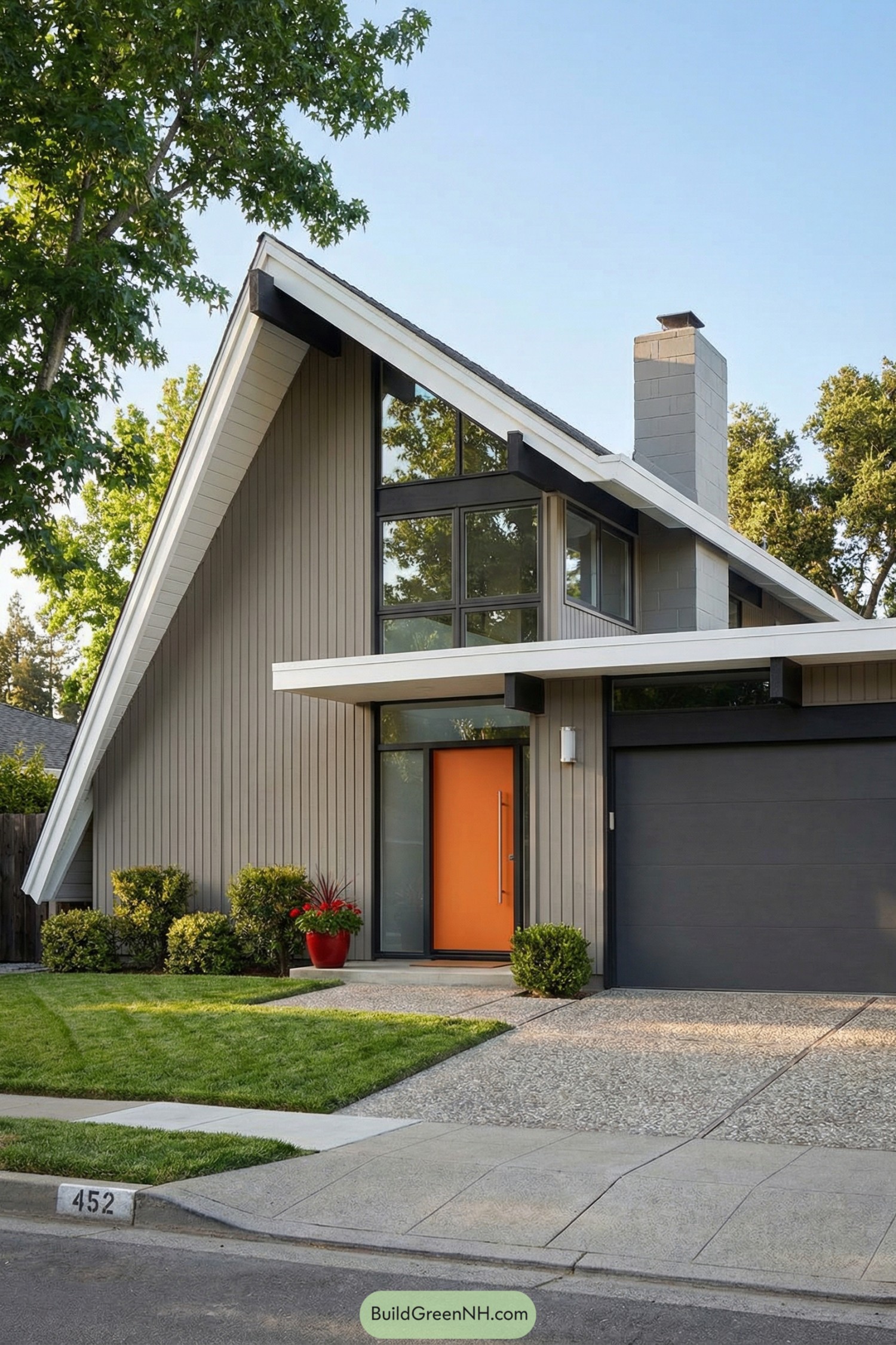 A-frame midcentury house with orange door and tall glass