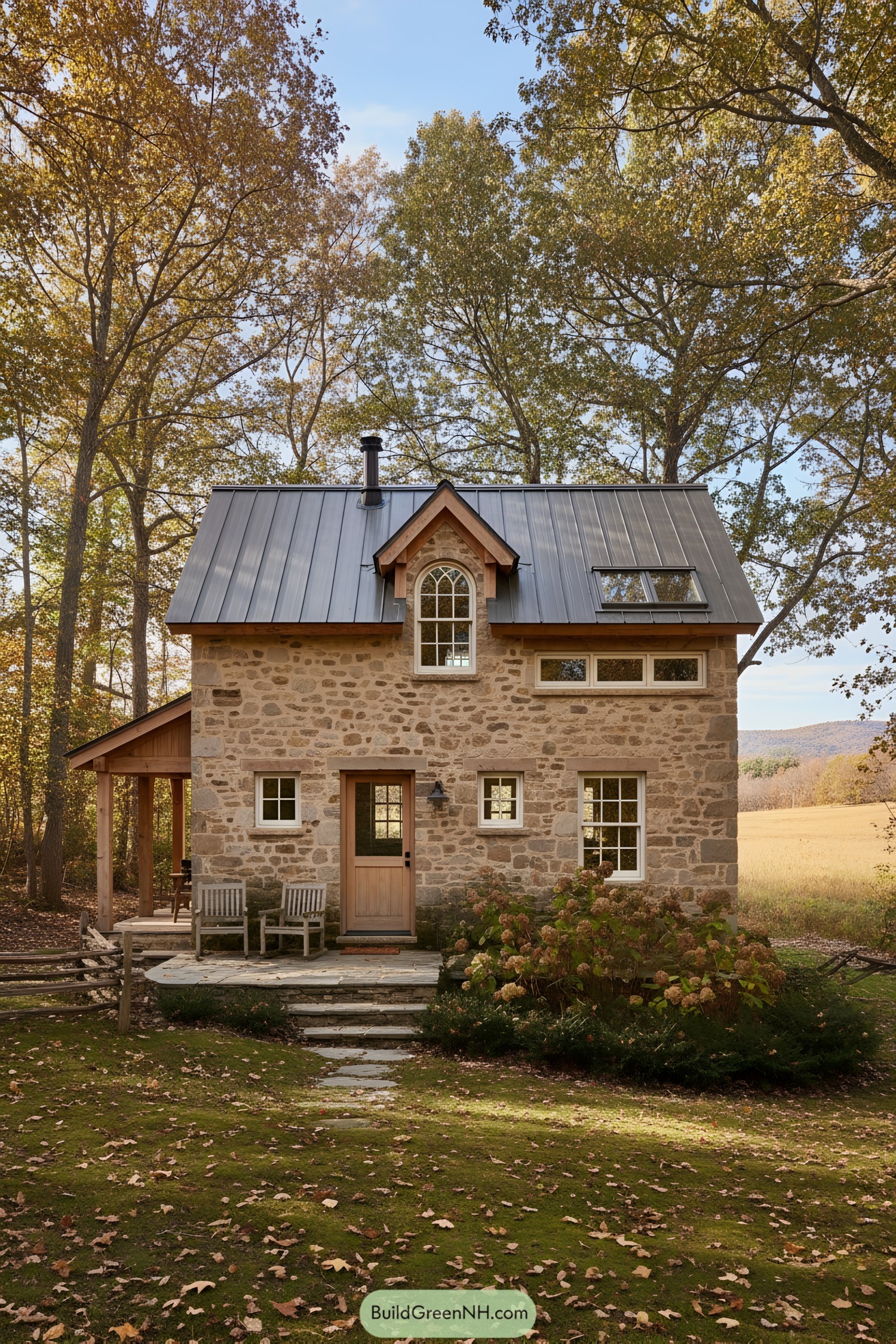 Small stone cottage with metal roof and arched dormer