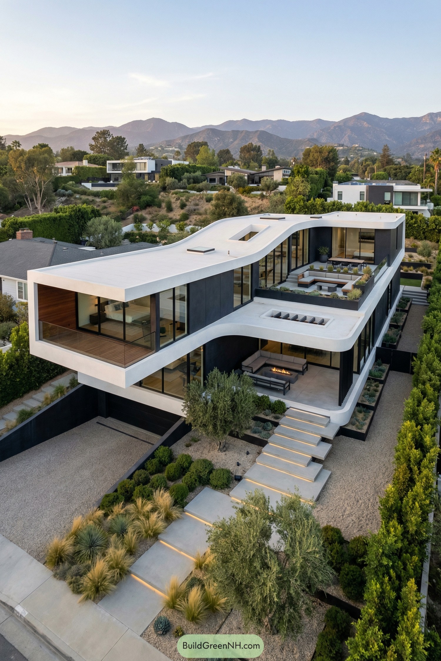 Modern two-story hillside home with flowing white roofline and open terraces