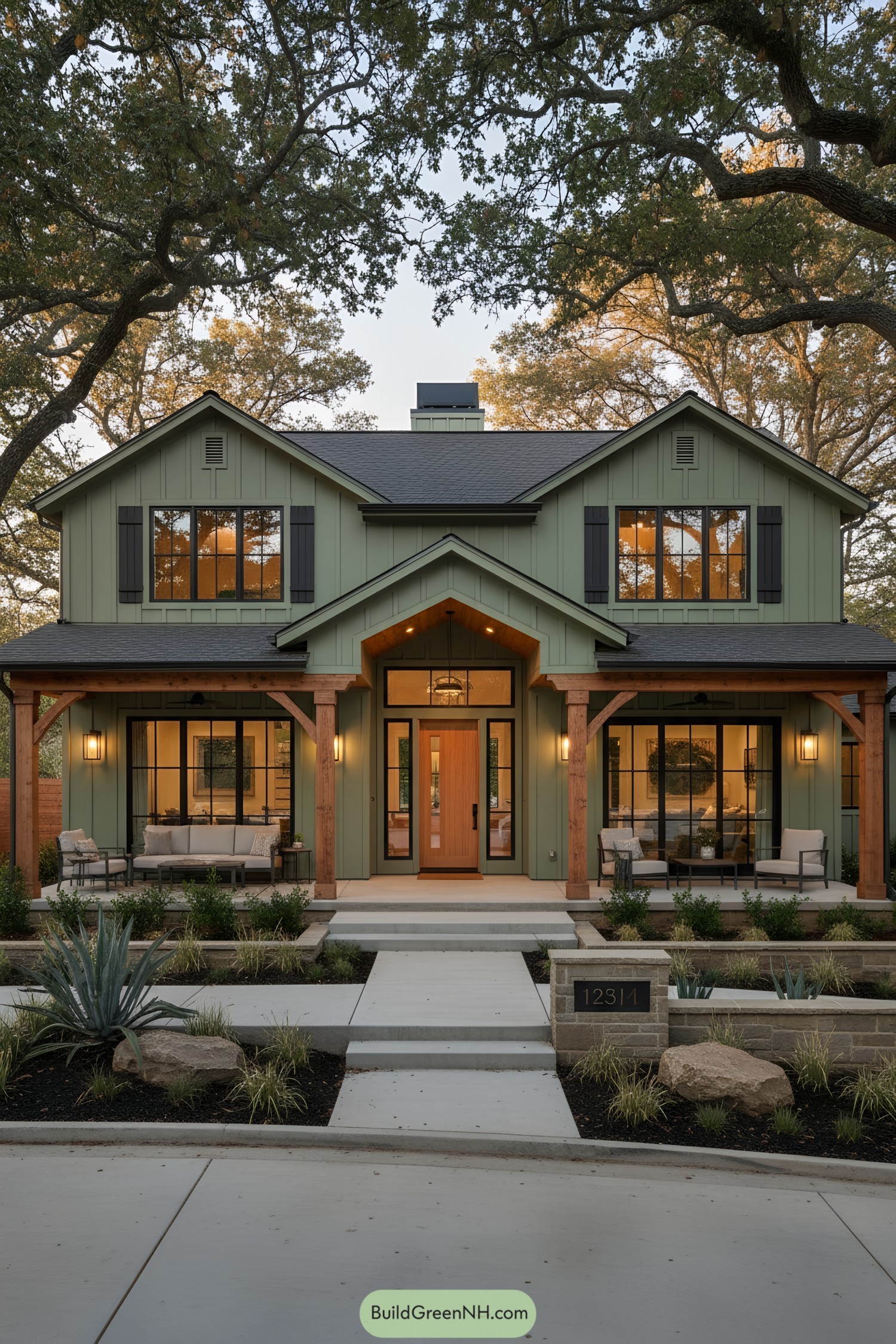 Green board-and-batten ranch with timber porch and black window grilles at sunset