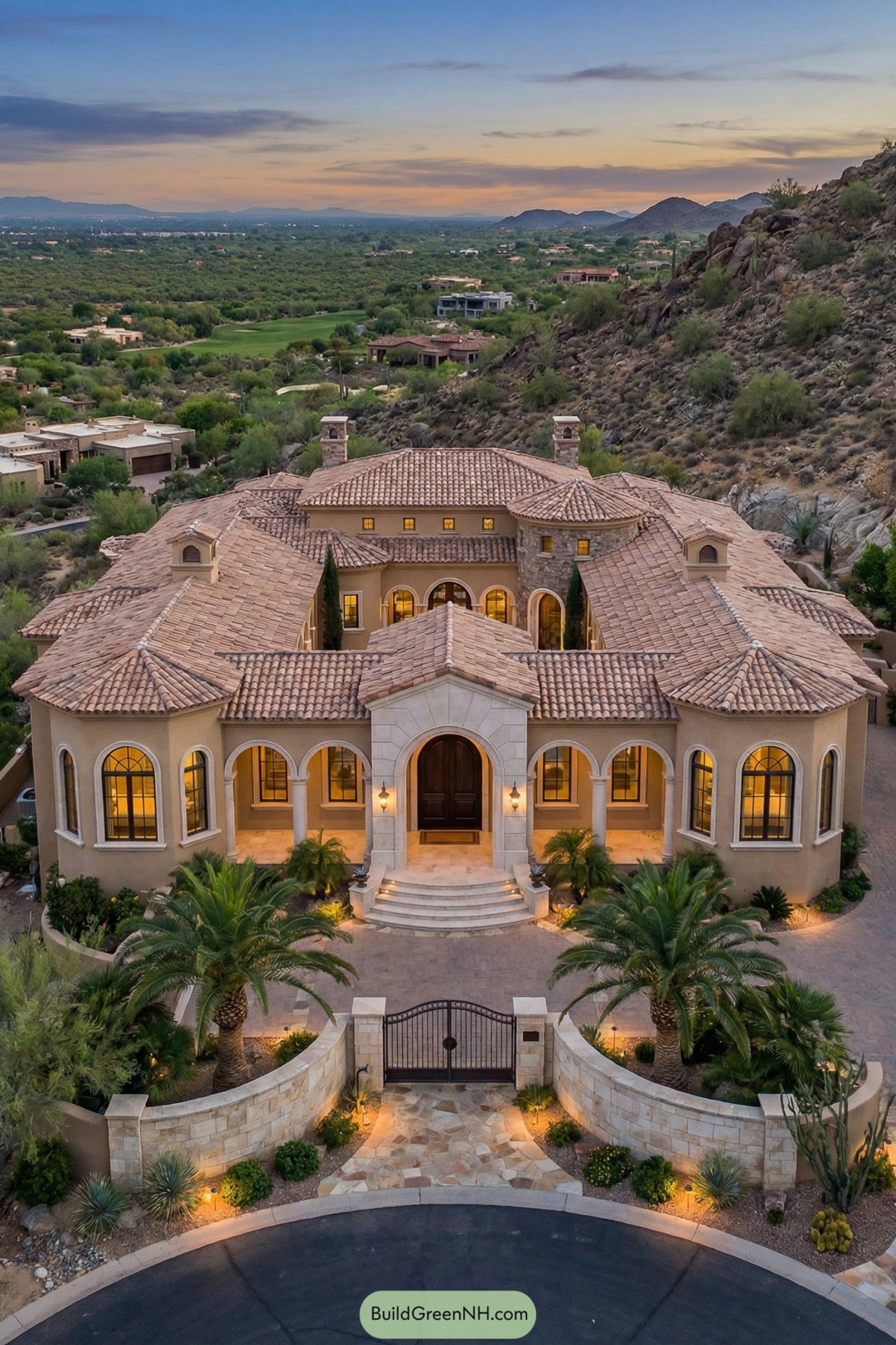 Mediterranean-style mountain mansion with arched façade and terracotta roofs at sunset