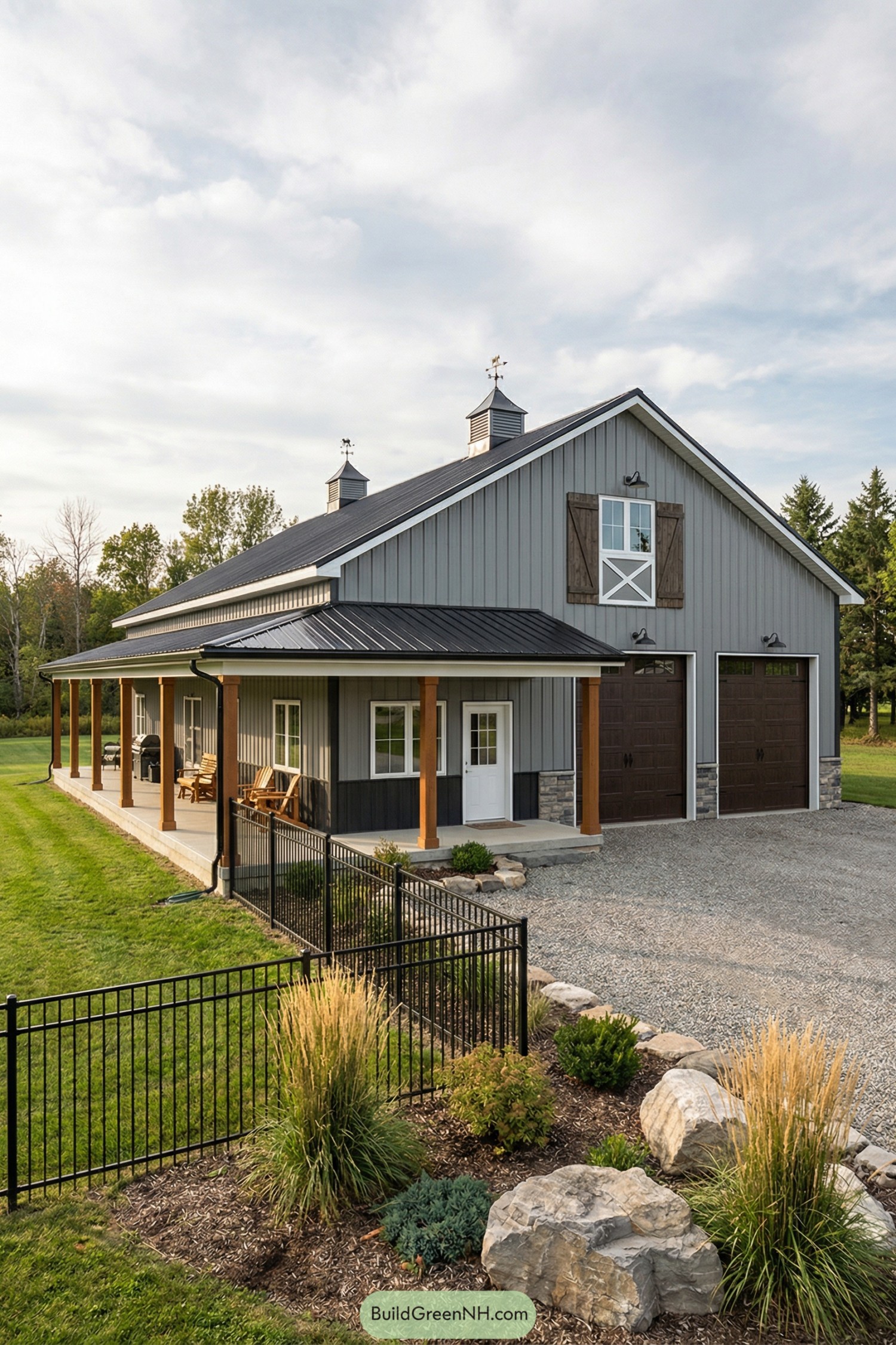 Gray metal barndo with wraparound porch and tall garage doors