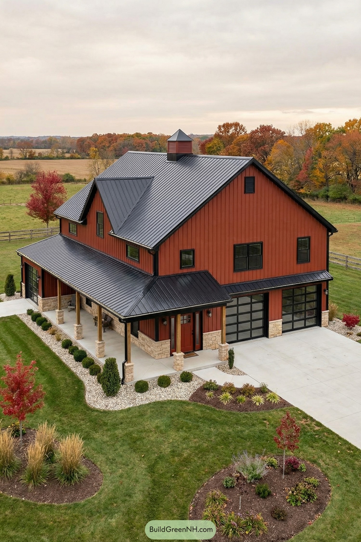 Red metal barndominium with black roof and glass garage doors