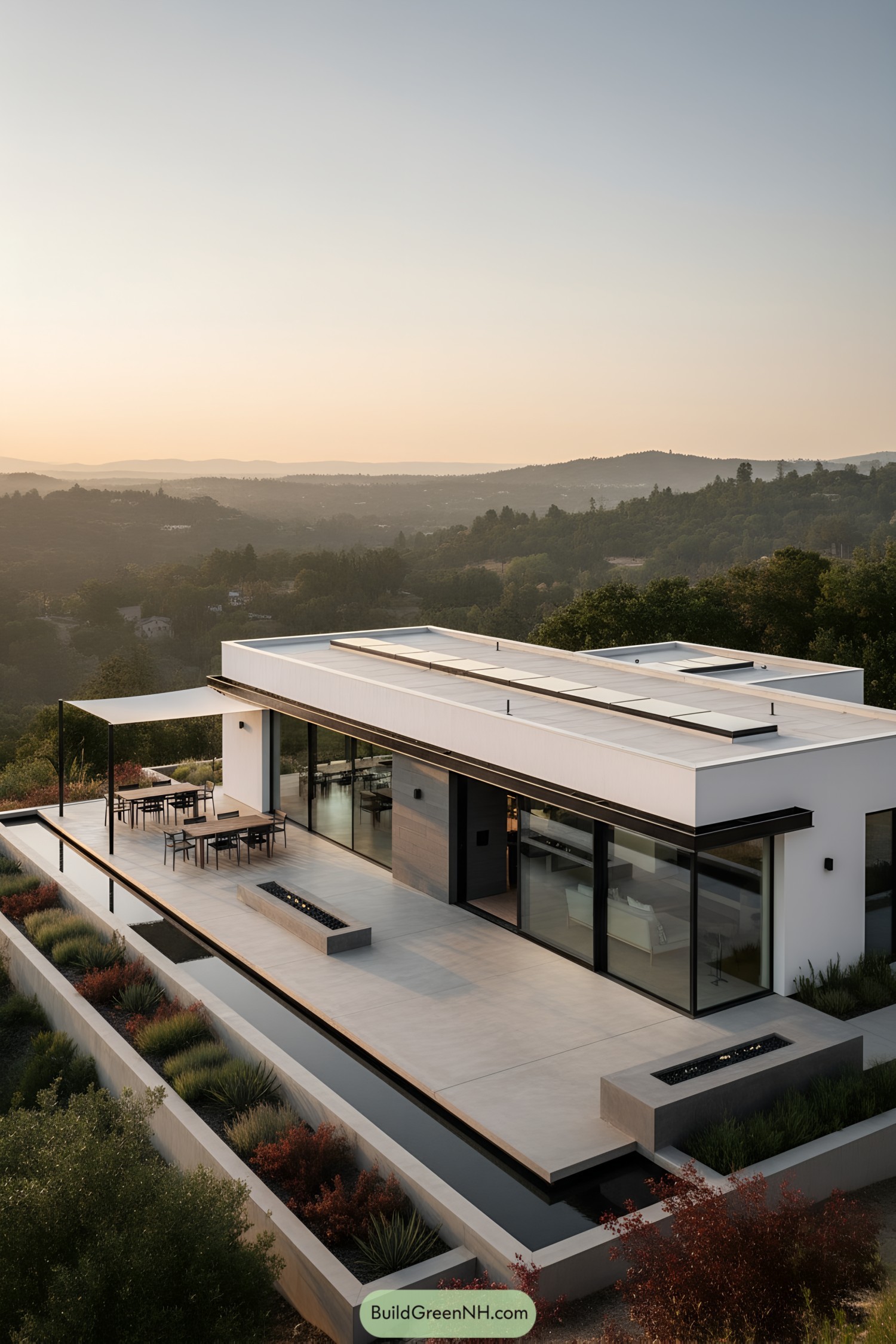 Minimalist white hillside home with terrace and reflecting pools
