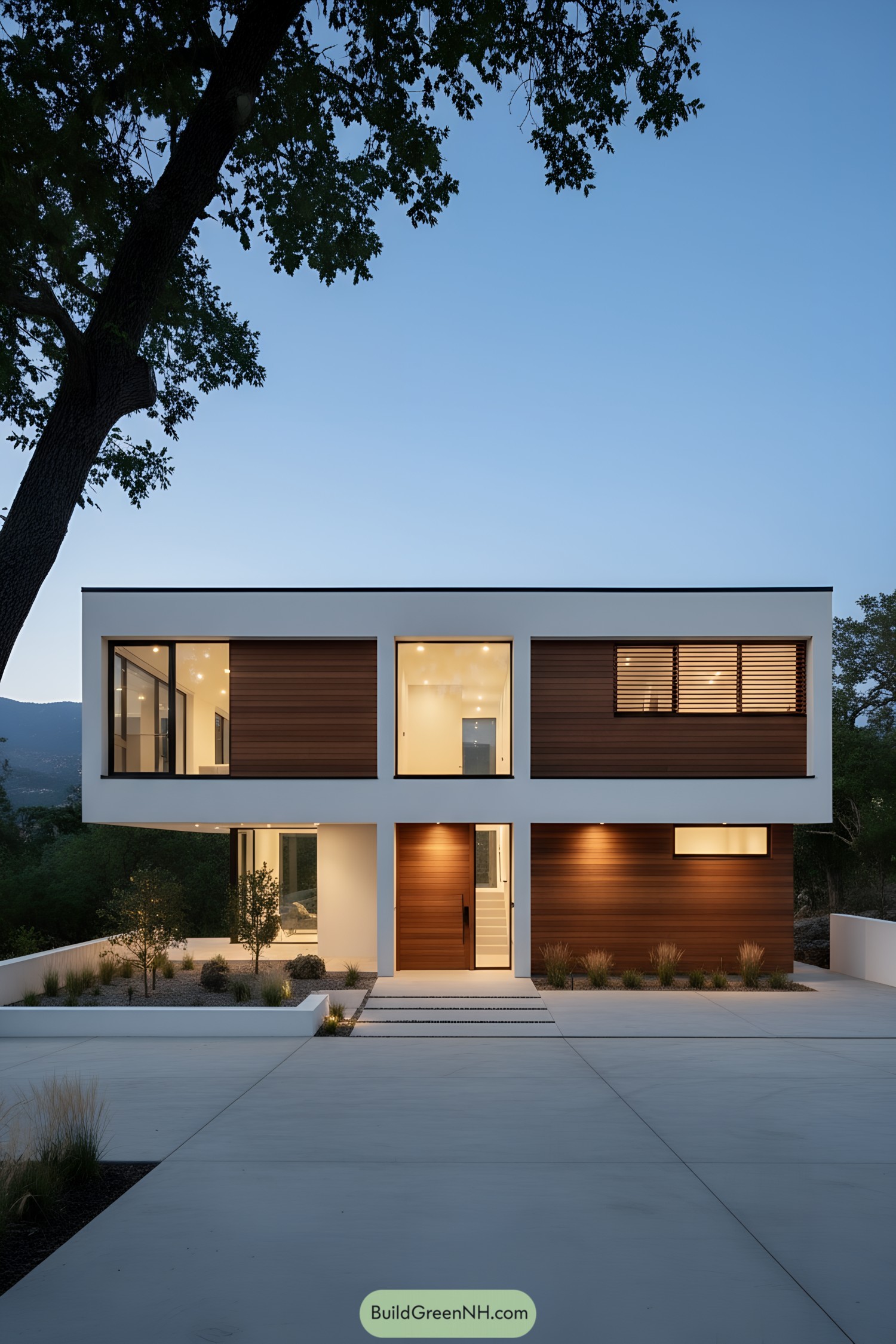 Modern two-story minimalist house with white rectilinear frame, cedar cladding, and large windows at dusk