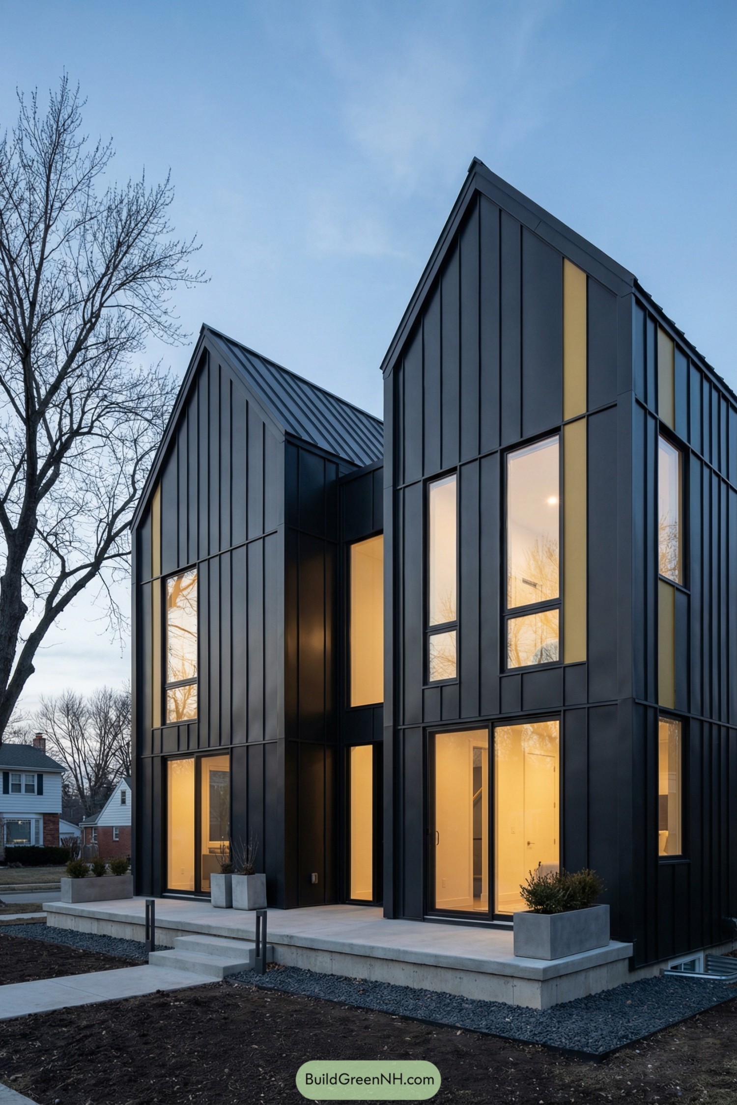 Modern black twin-gabled house with tall windows and warm interior lighting at dusk