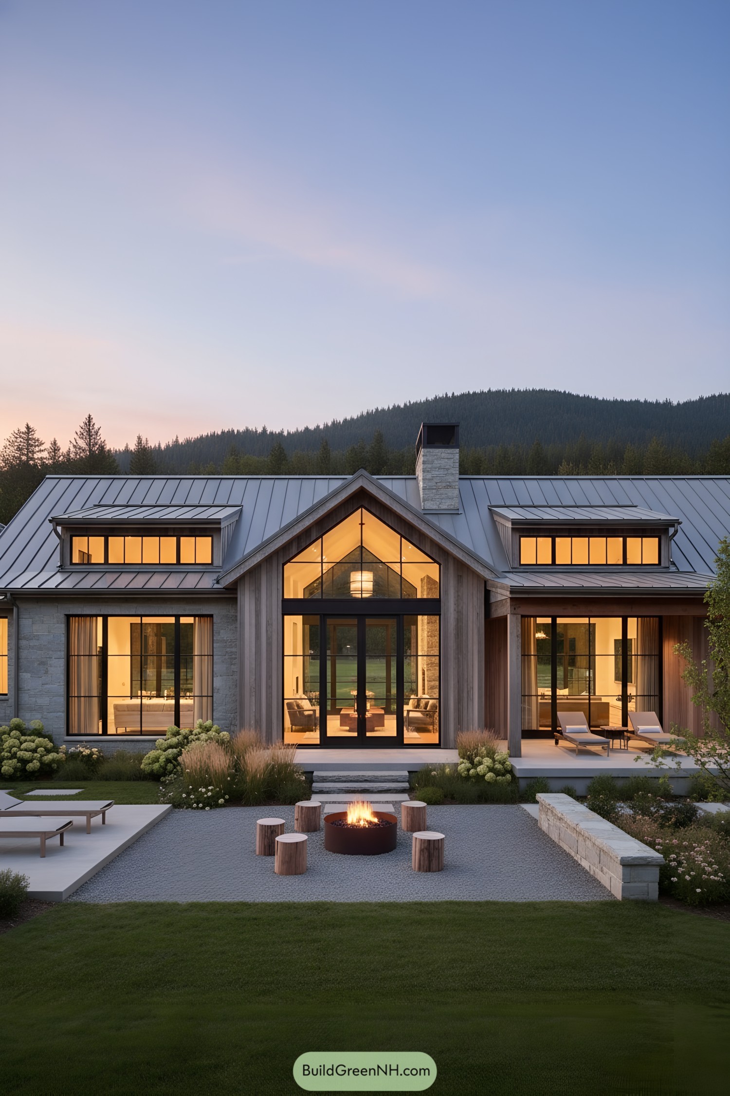 Modern ranch with metal roof and glass gables at dusk