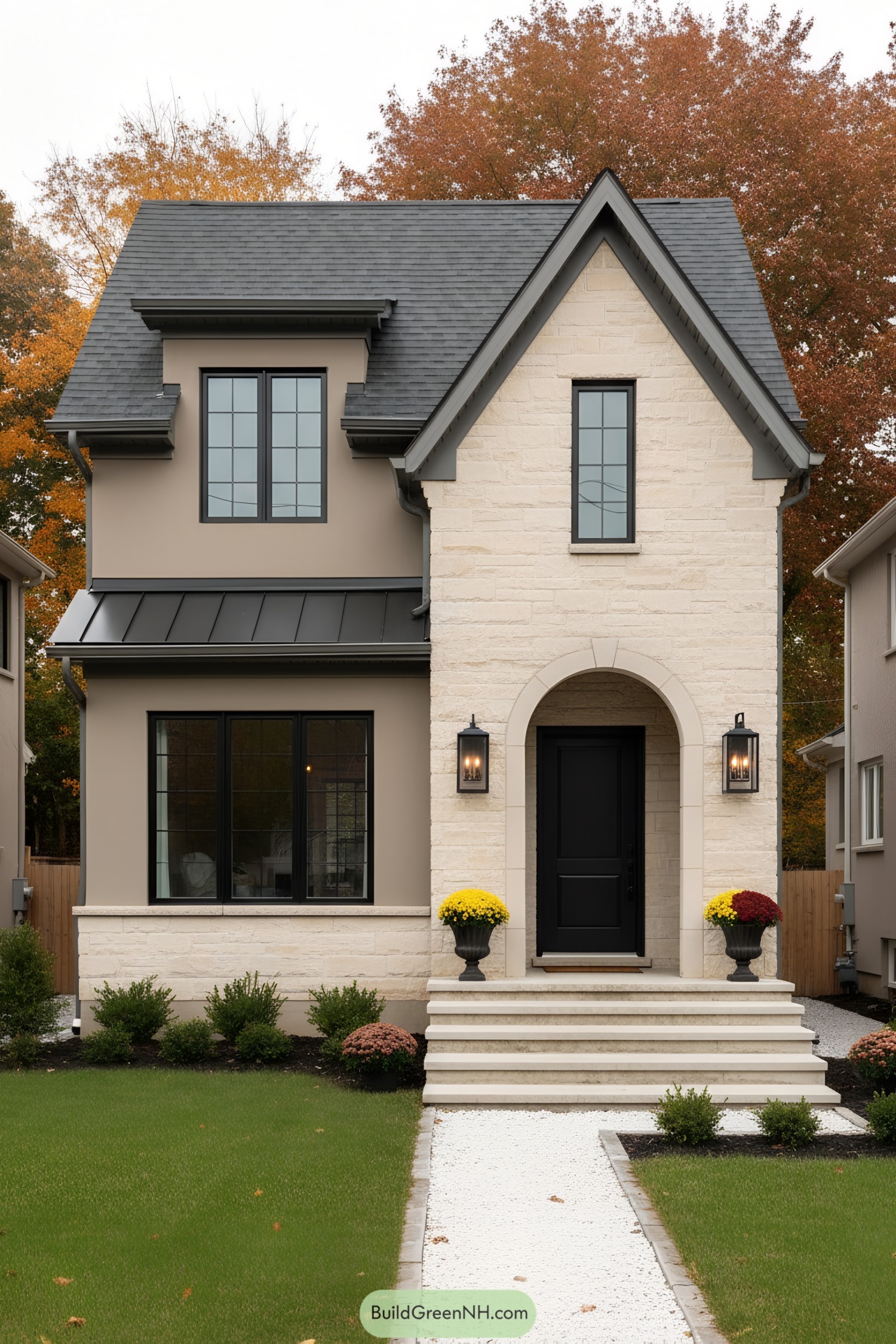 Compact two-story house with cream stone facade, arched entry, and black-trim windows