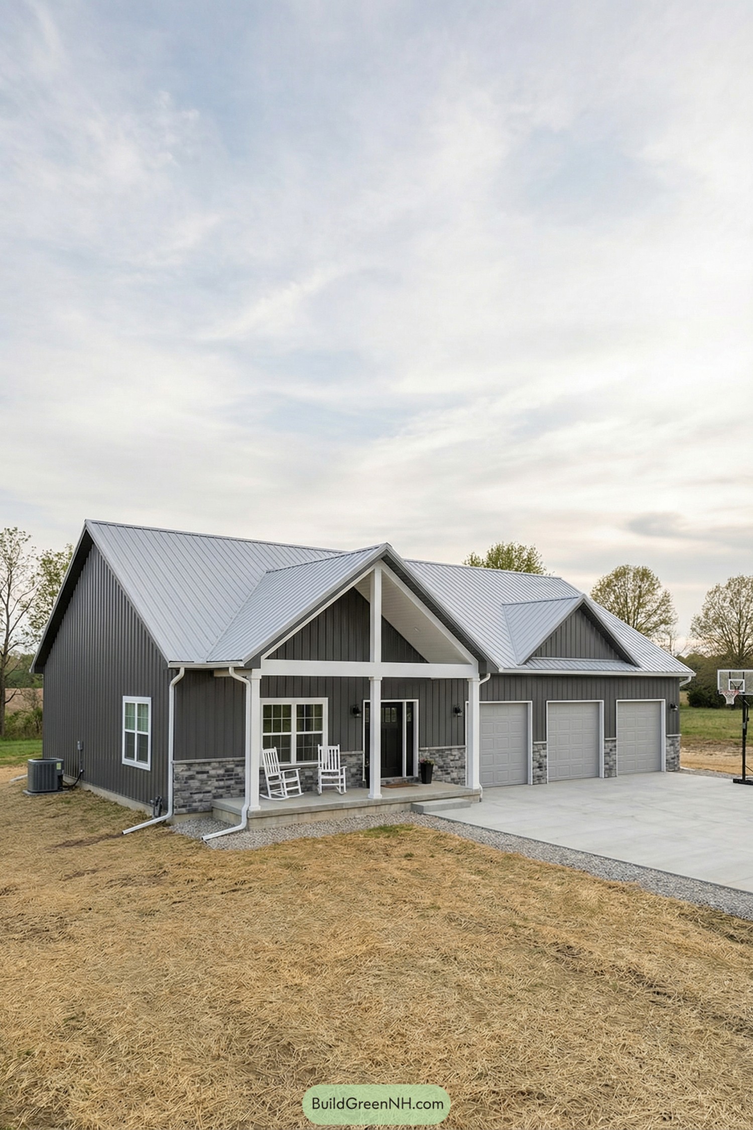 Gray pole barn home with triple garage and porch
