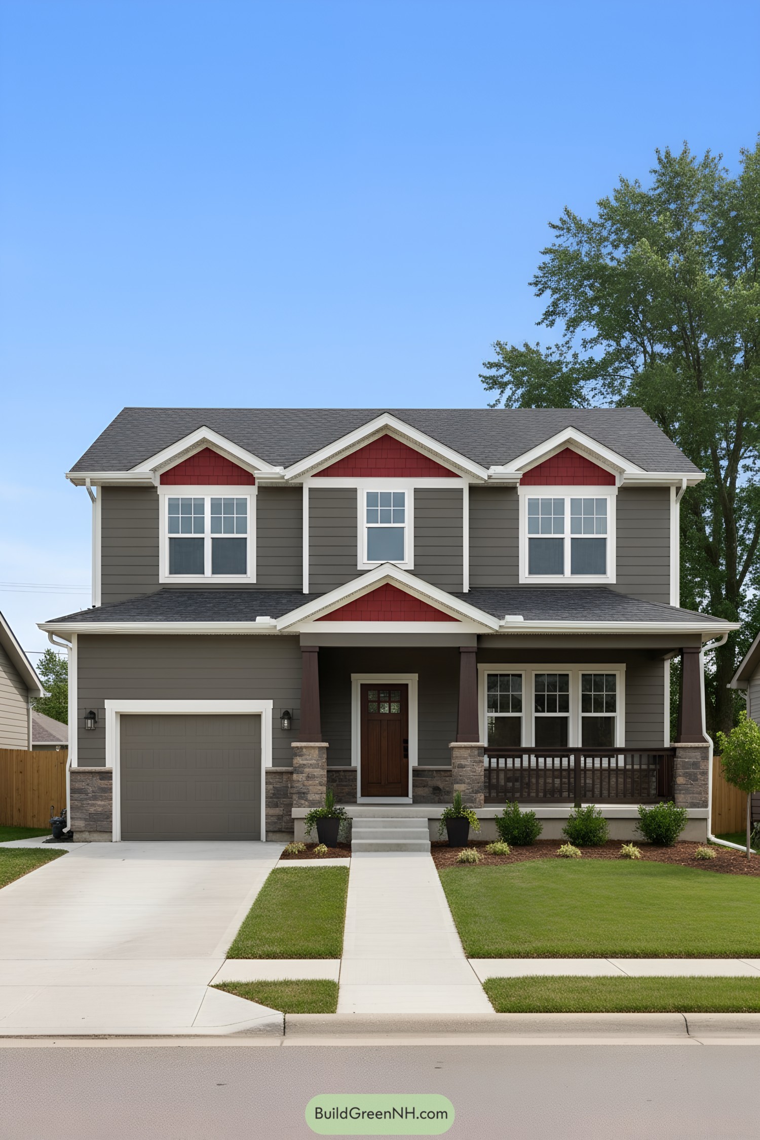 Two-story gray house with red gable accents, white trim, and stone base
