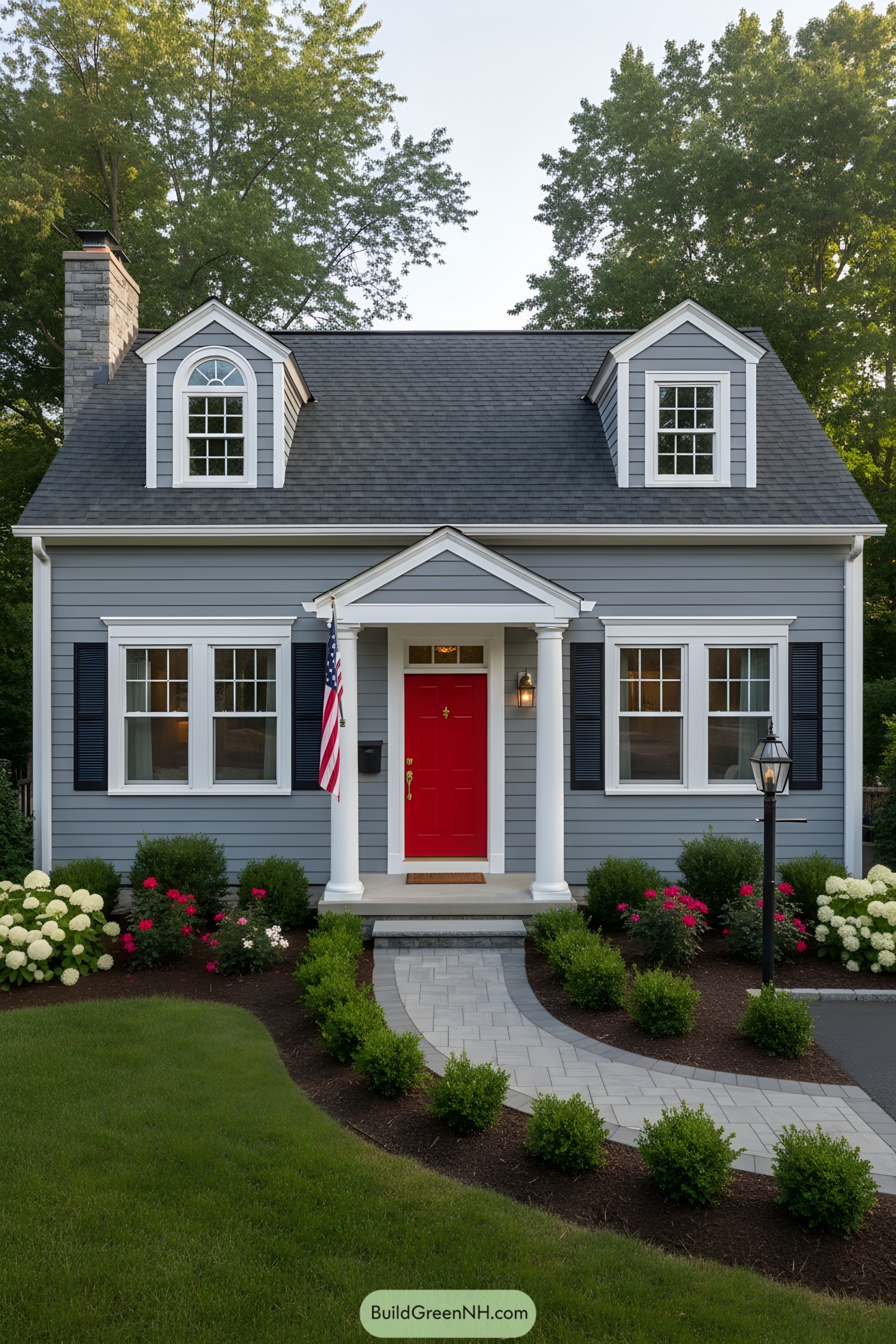 Gray siding cottage with red door and white trim