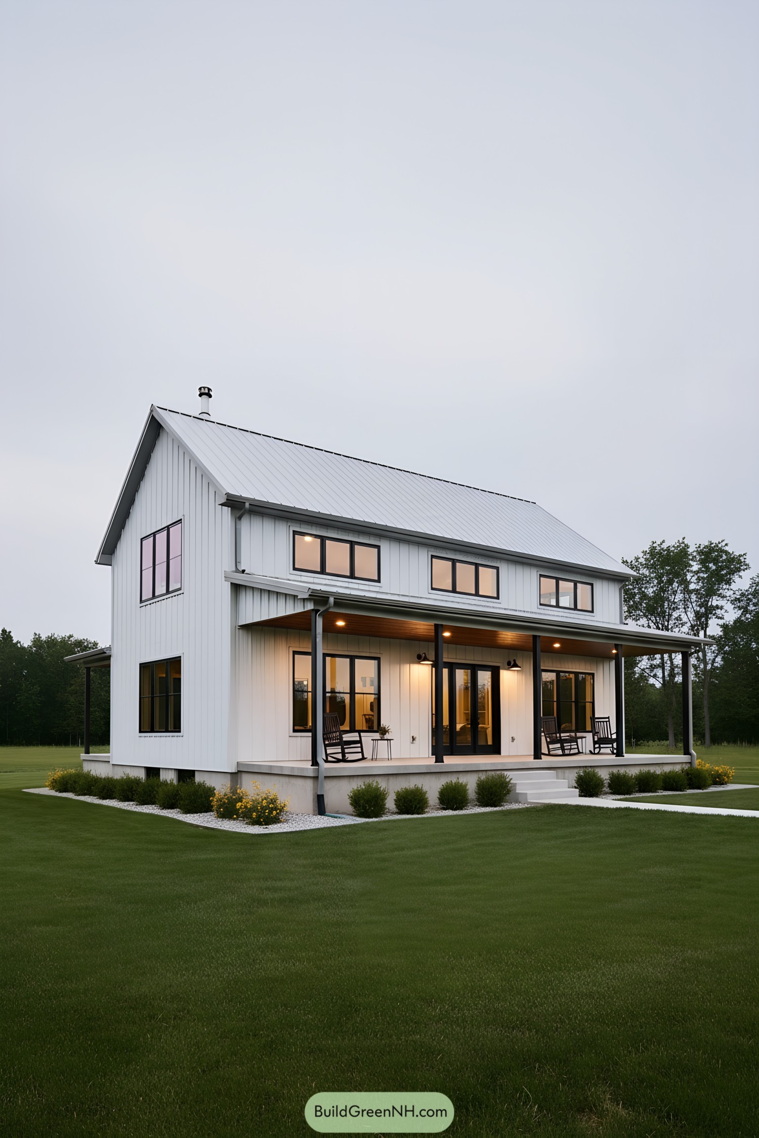 White steel farmhouse with wraparound porch at dusk