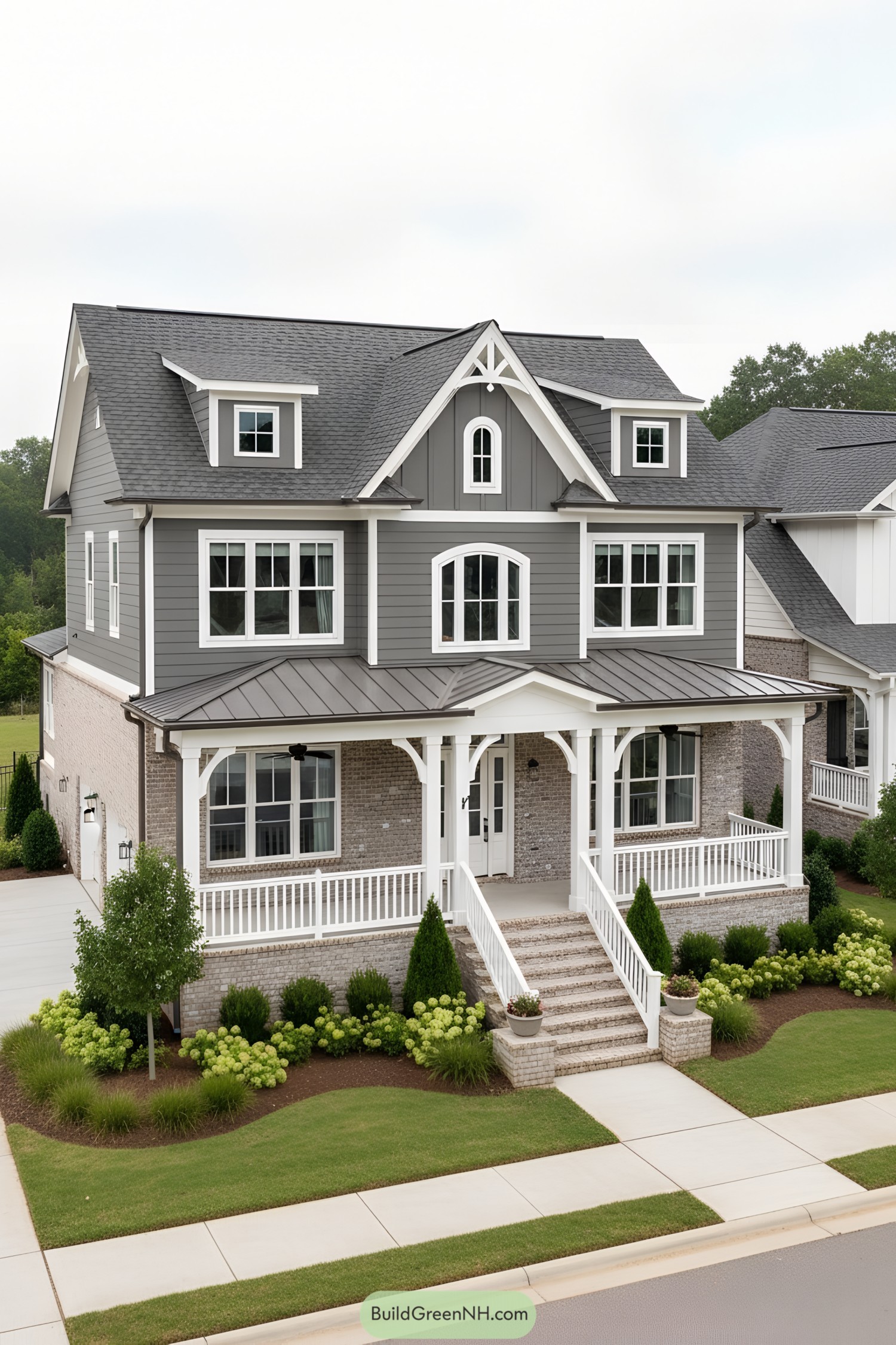 Gray farmhouse with wraparound porch and dormers
