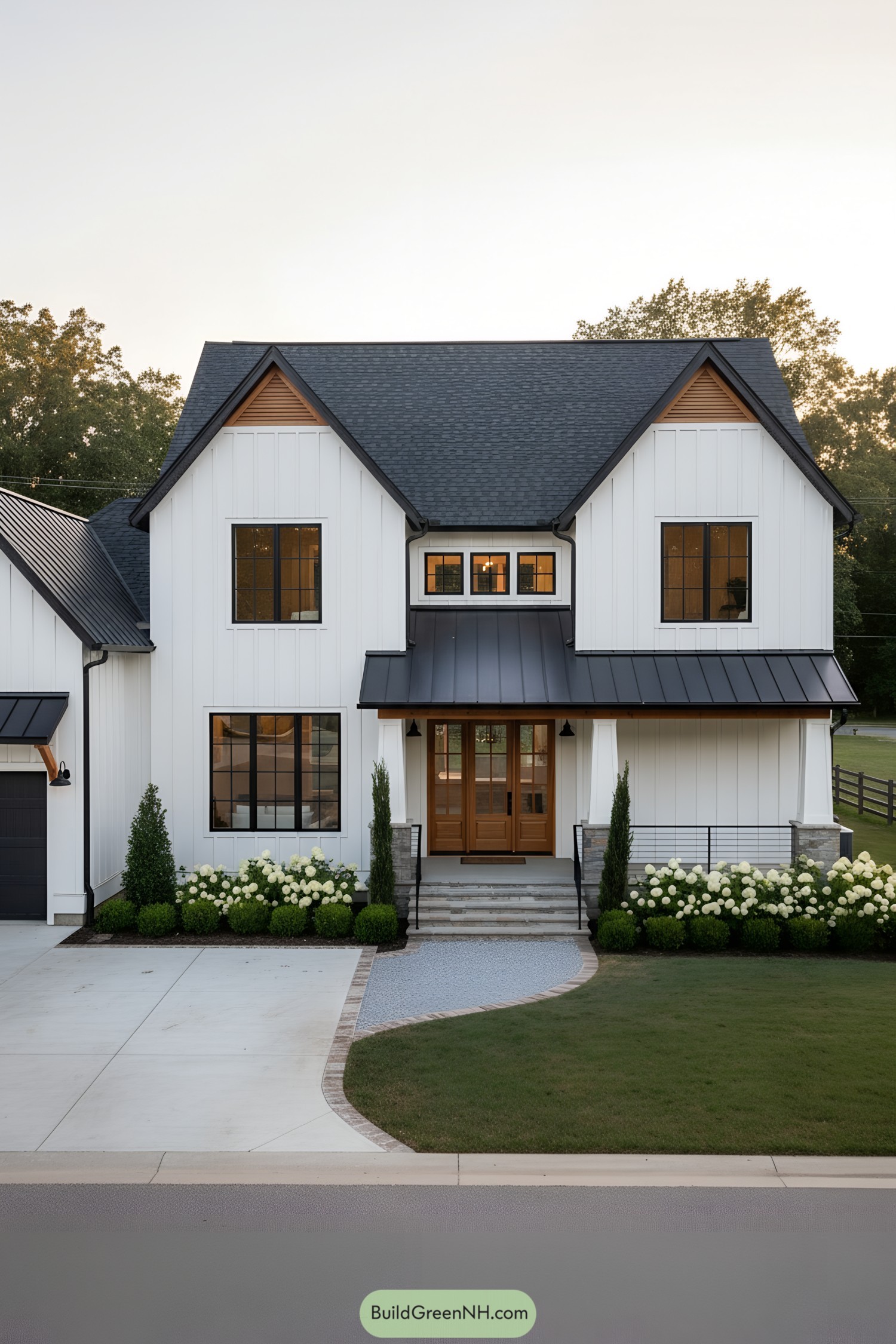 White farmhouse with black metal awnings and warm wood door