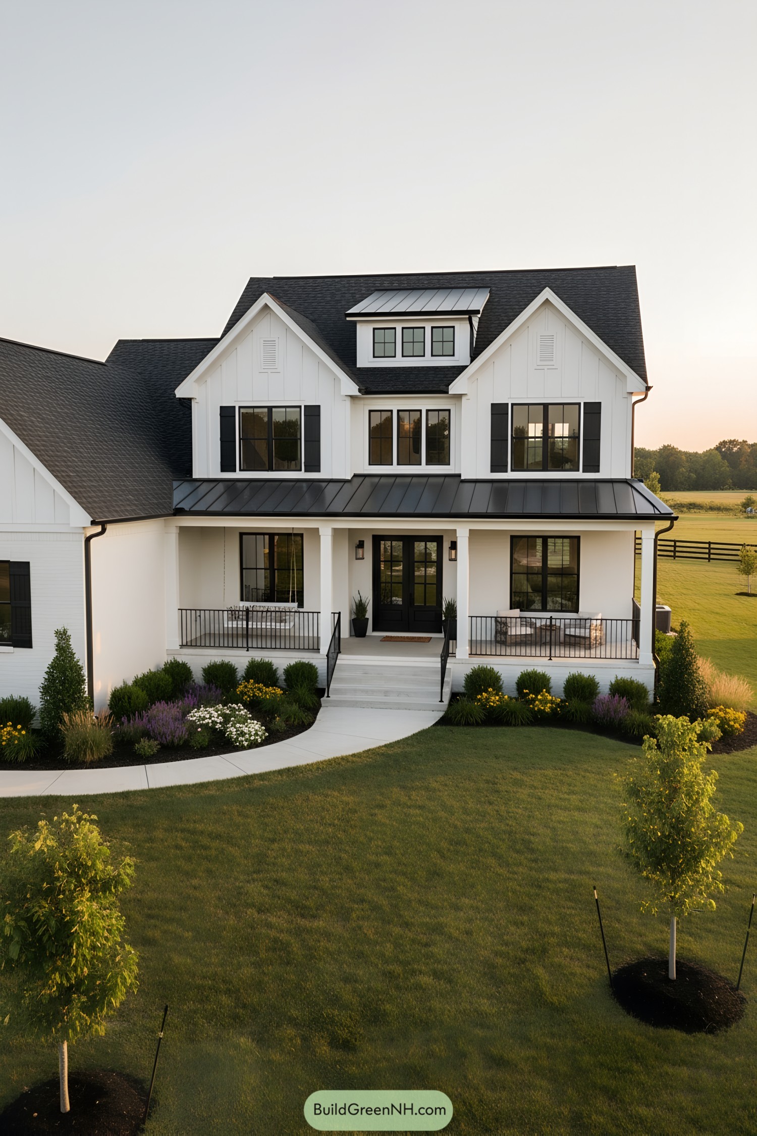 White farmhouse with black metal accents and wraparound porch
